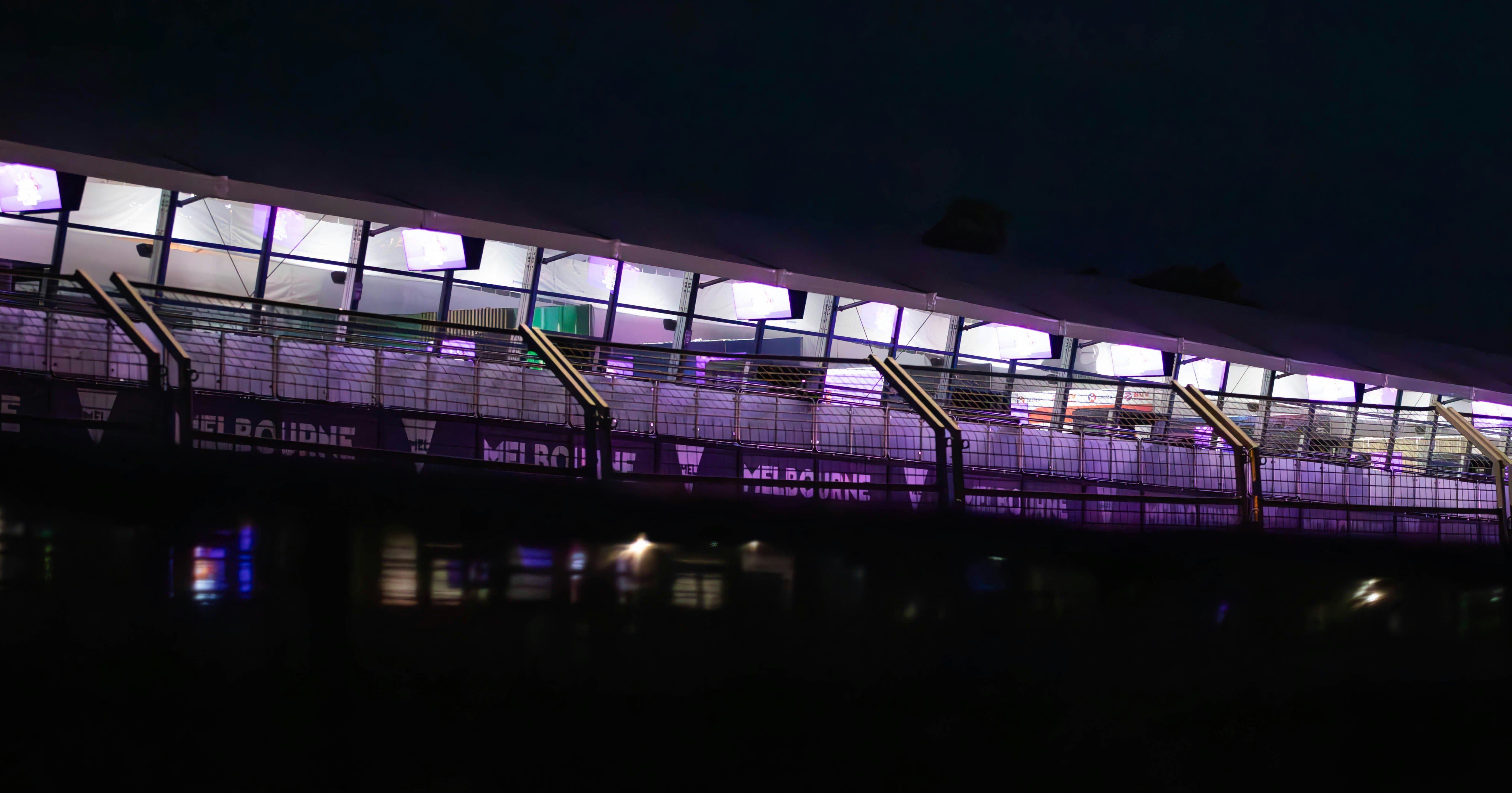 Modern building illuminated with purple lights at night