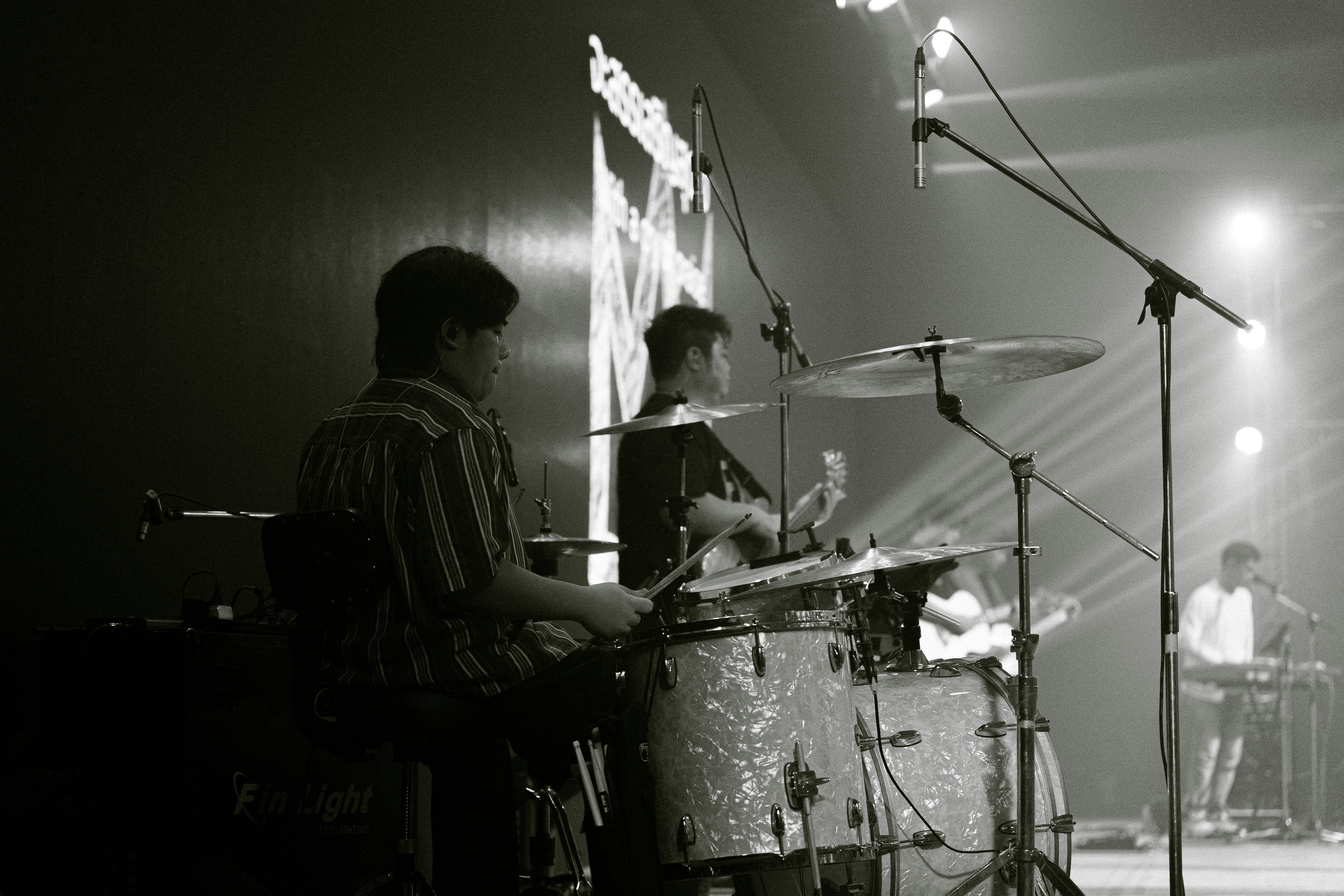 Band performing on stage with spotlights