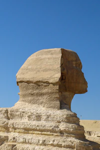 The great sphinx of giza under a clear blue sky.