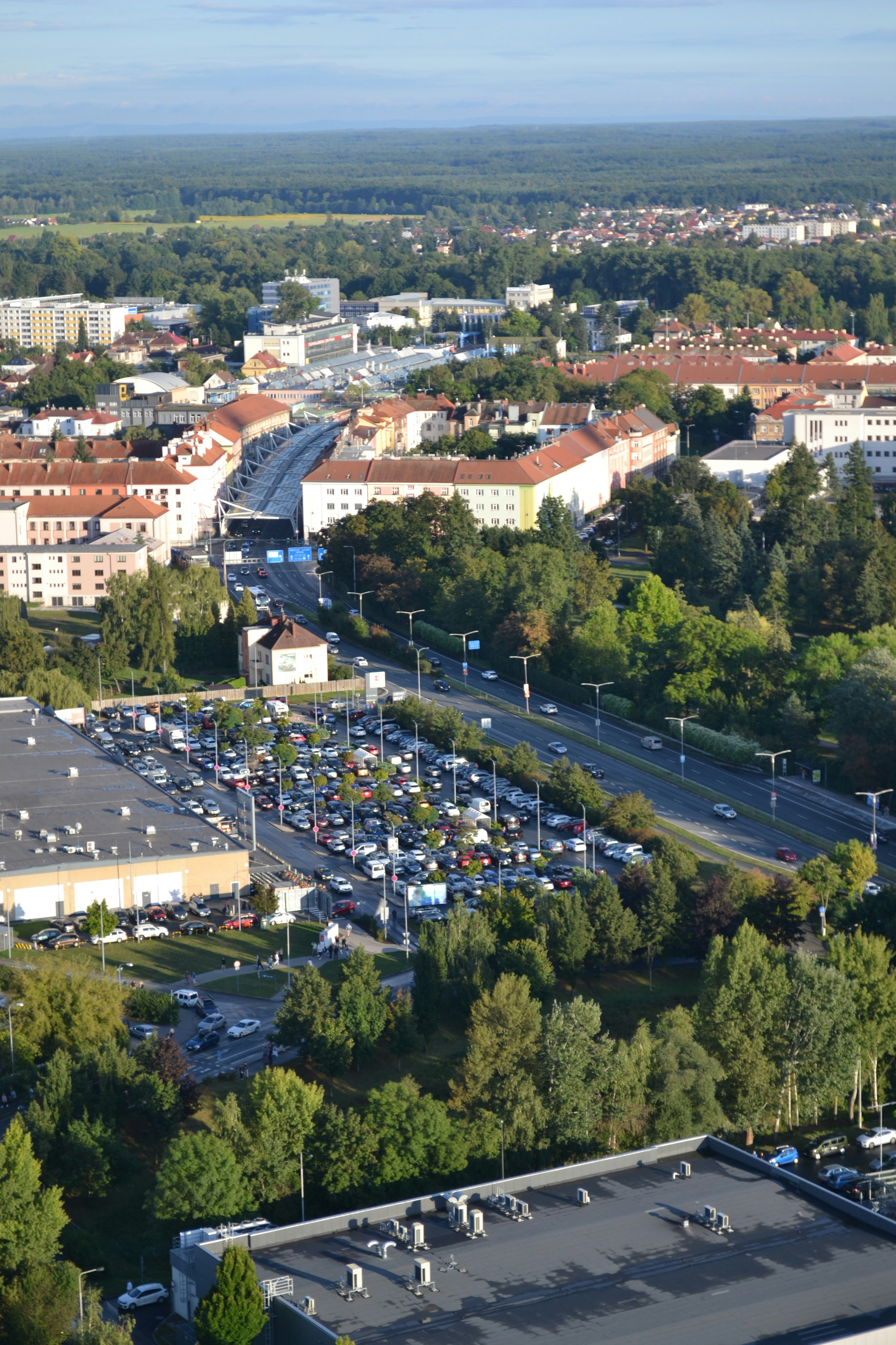 Aerial view of a busy city street with a large parking lot.