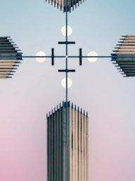 Symmetrical modern architecture against a pastel sky