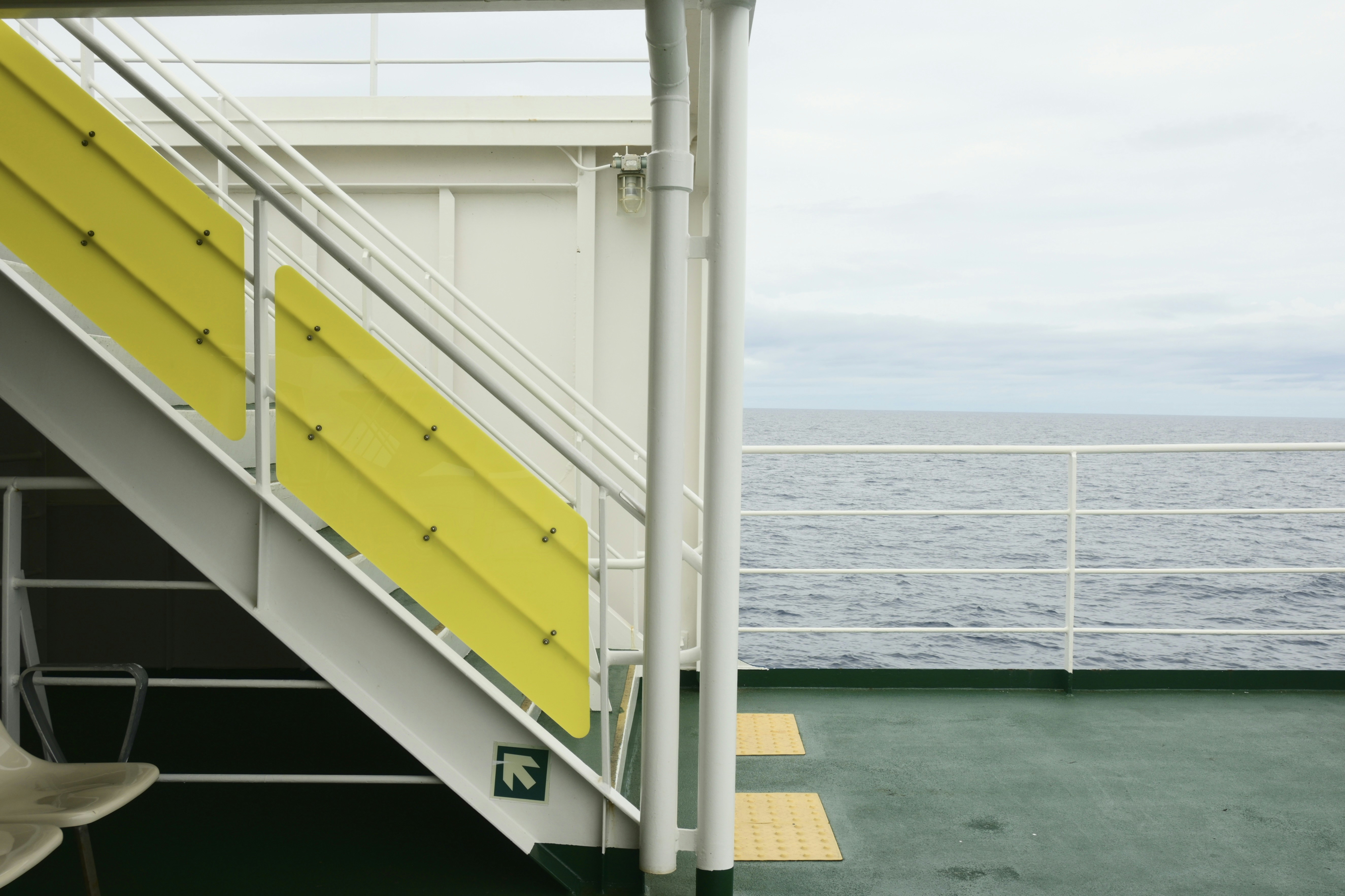 Staircase on a ferry deck overlooking the ocean