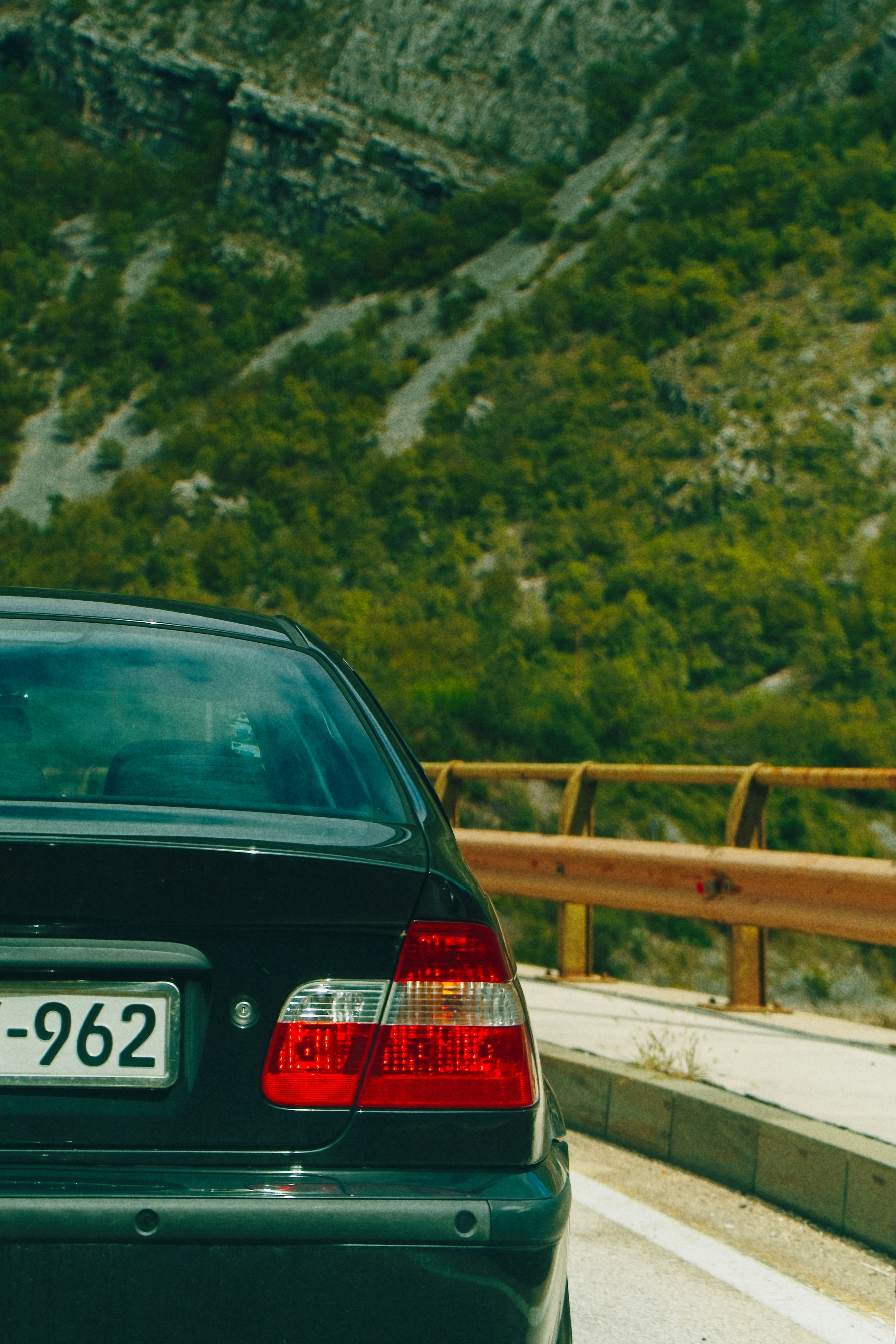 Voiture noire garée sur une route de montagne pittoresque