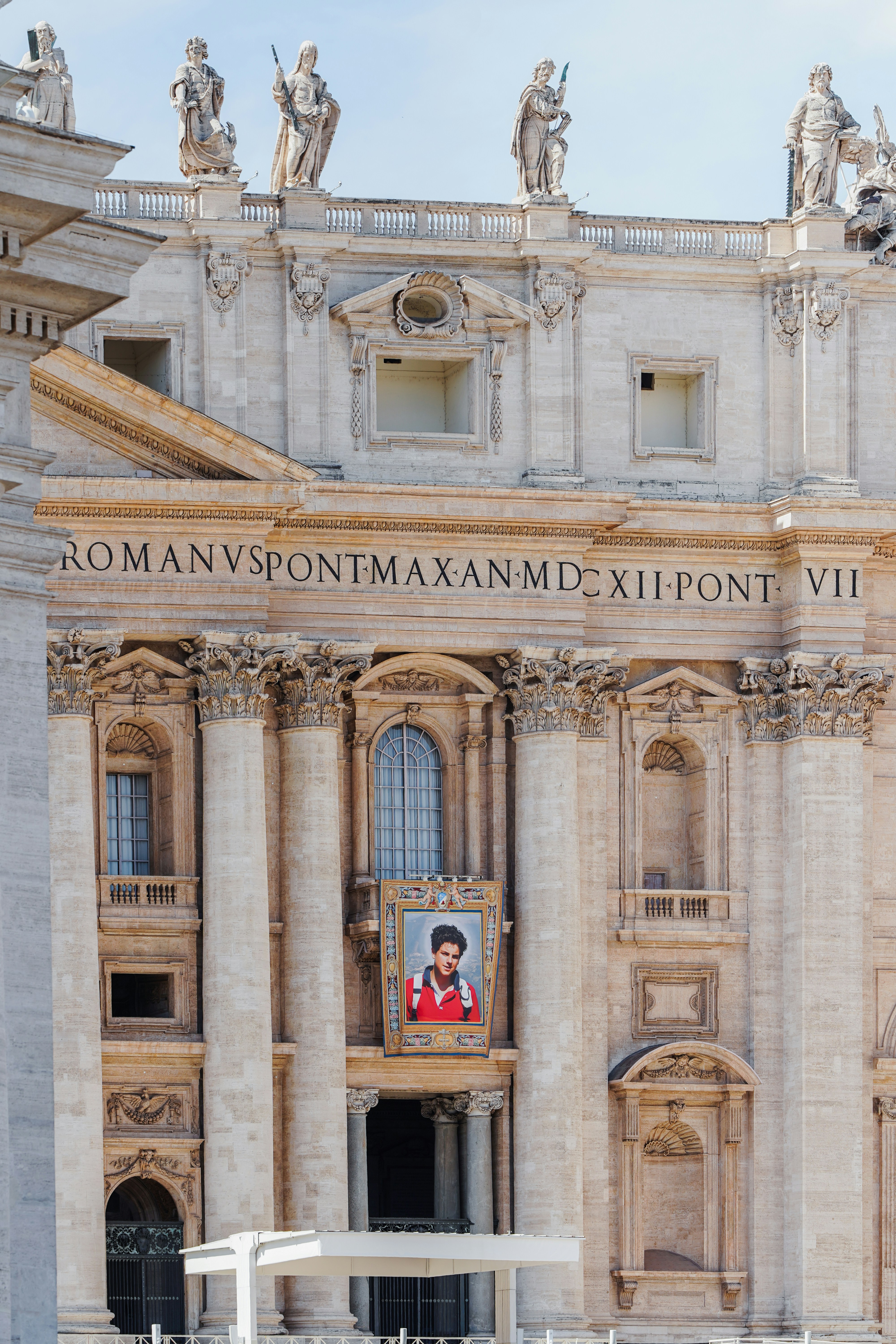 Portrait of pope francis displayed on vatican building facade