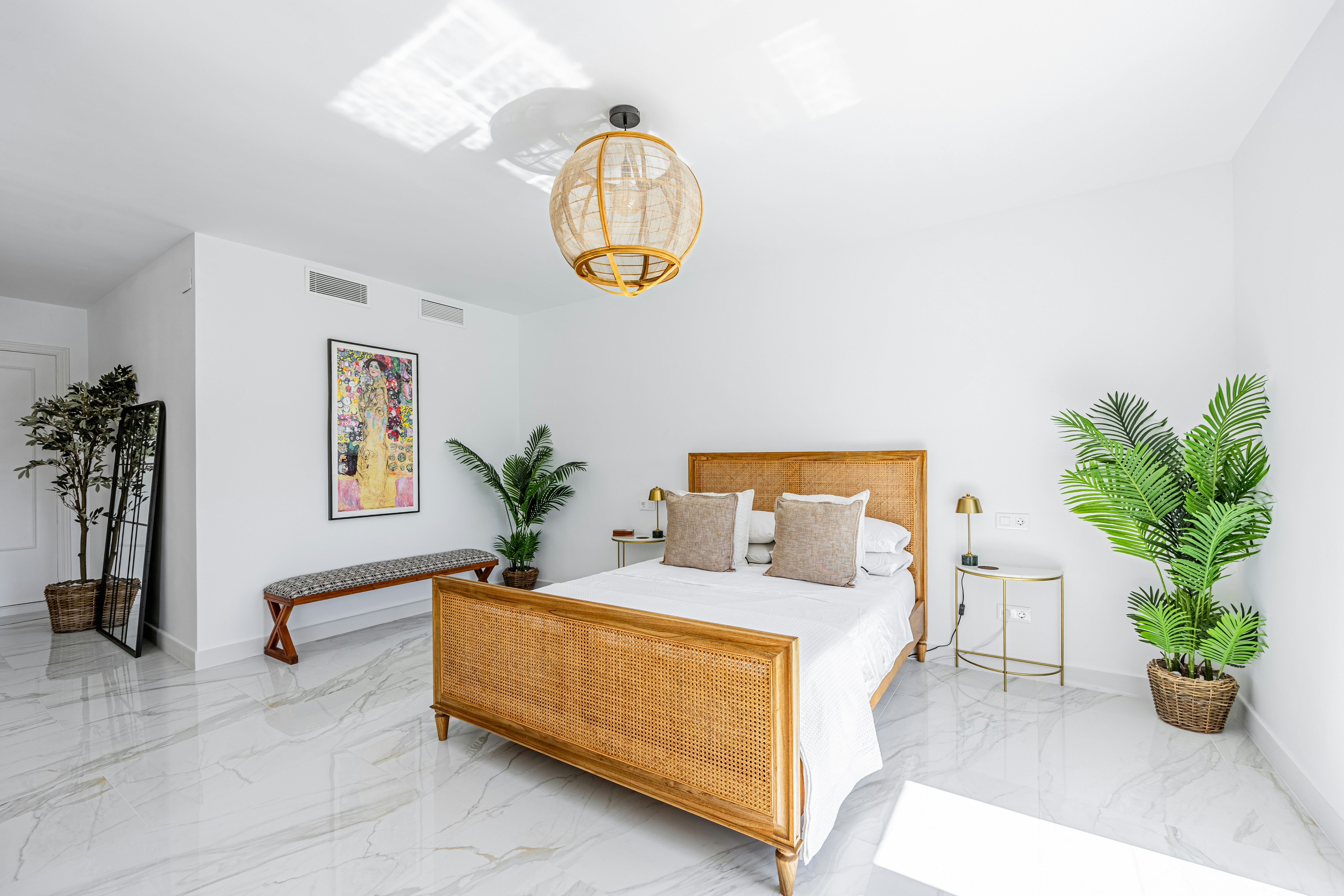 Upstairs primary bedroom with tropical light