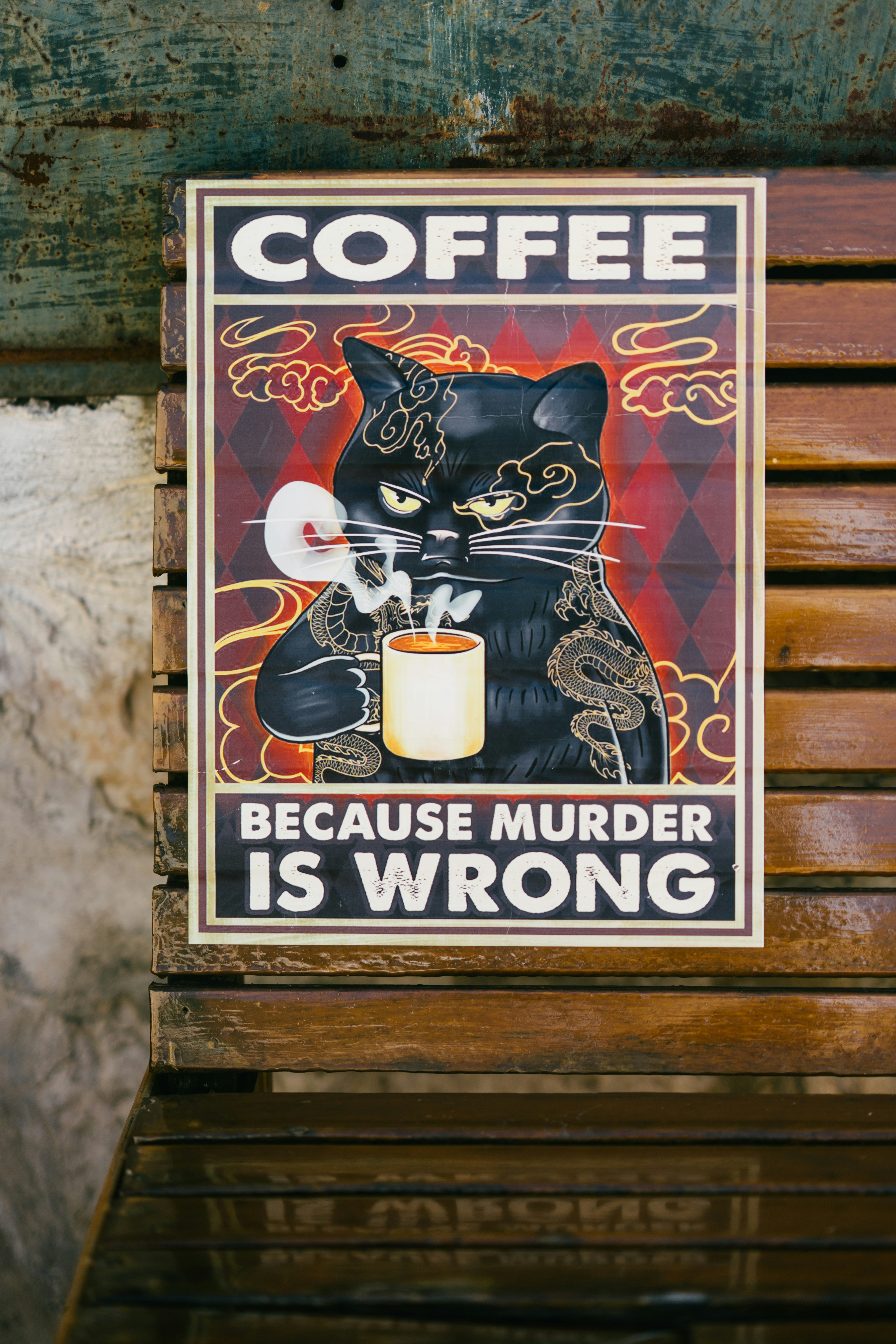 Tattooed cat holding coffee mug with "coffee because murder is wrong" text