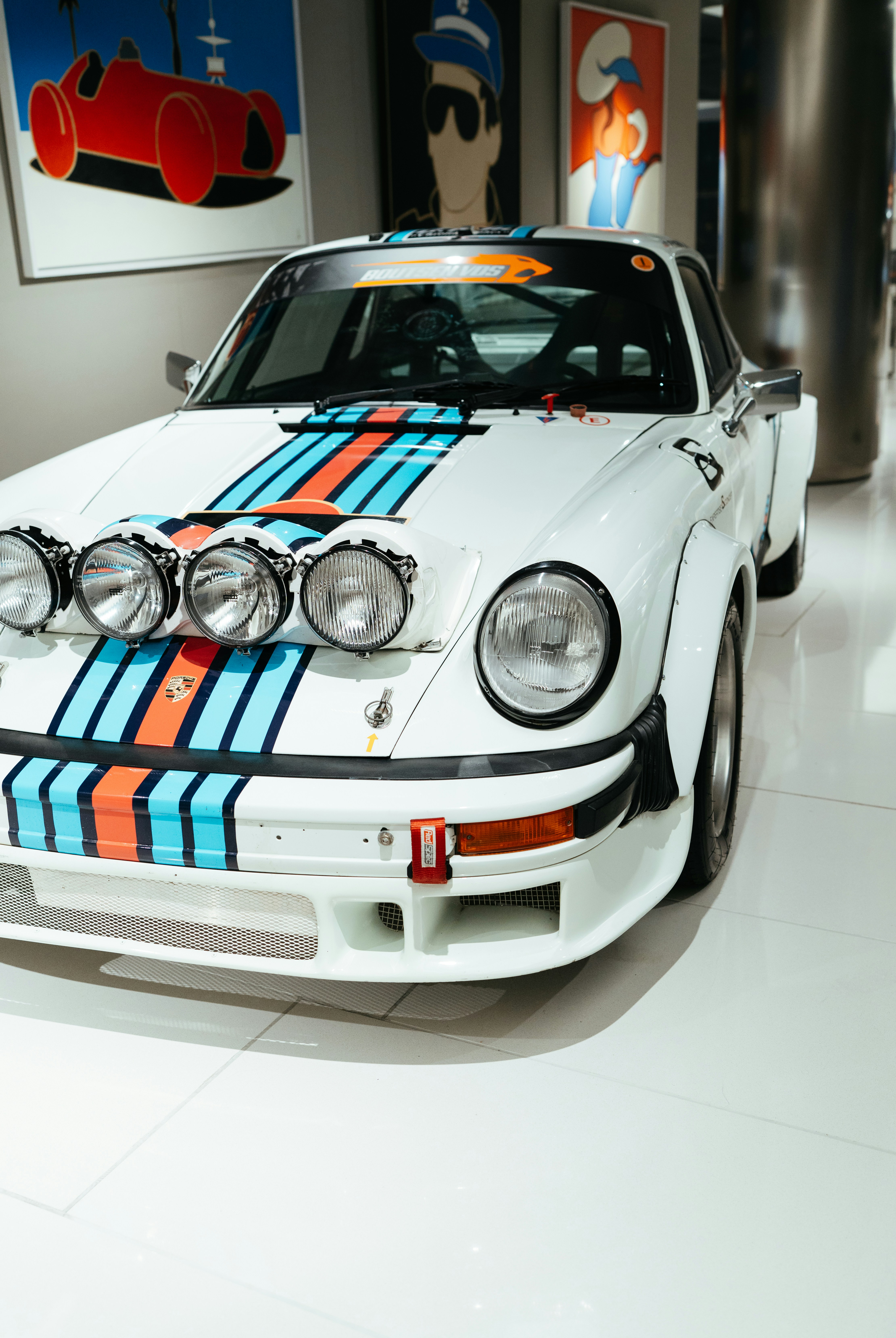 White race car with martini racing stripes and rally lights