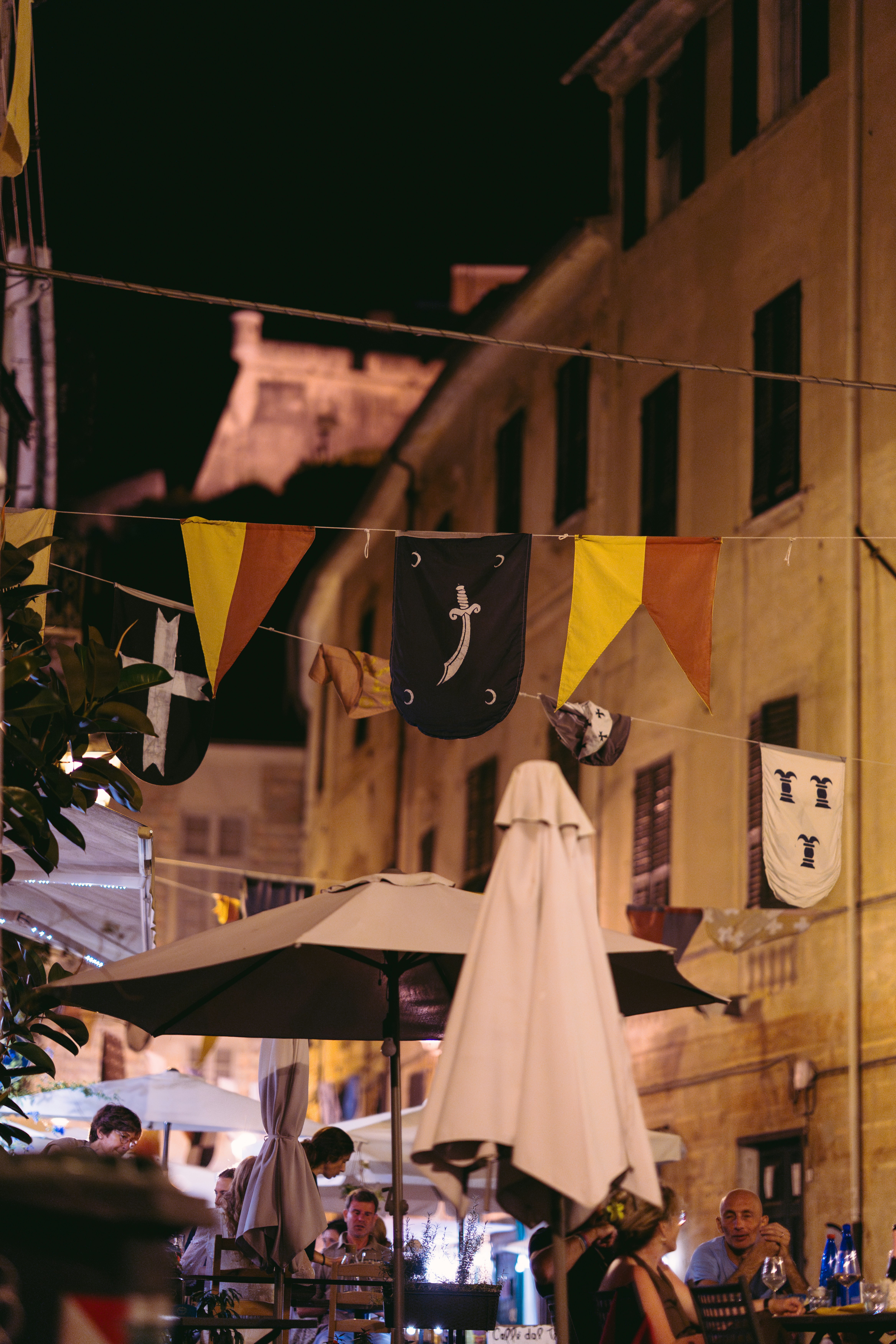 Street decorated with medieval banners at night