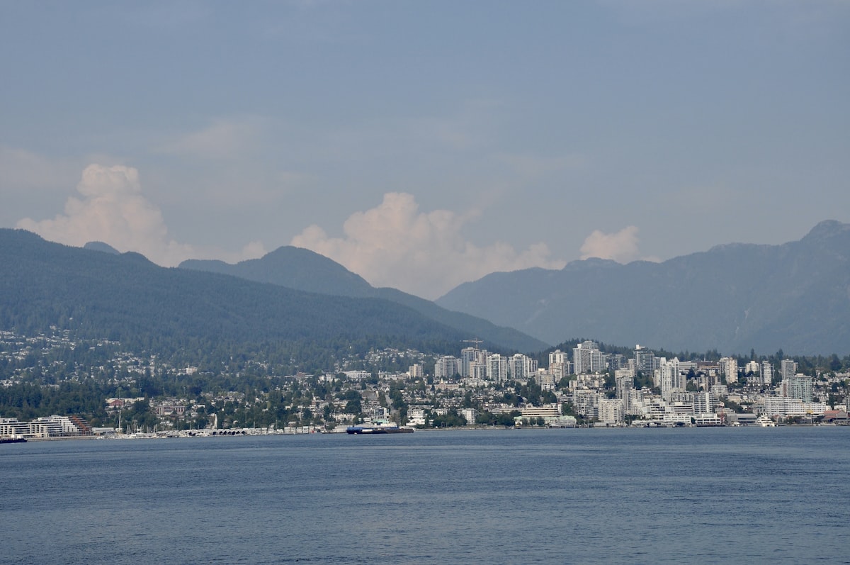 City skyline with mountains and ocean in foreground