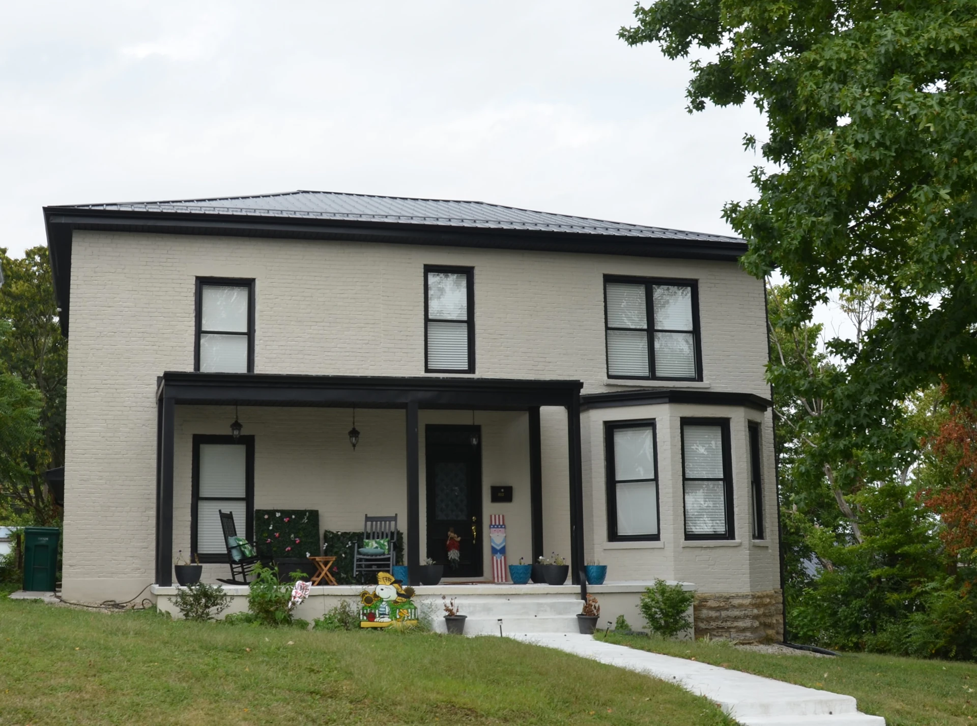 Large single-family house with a porch, suited to multigenerational living