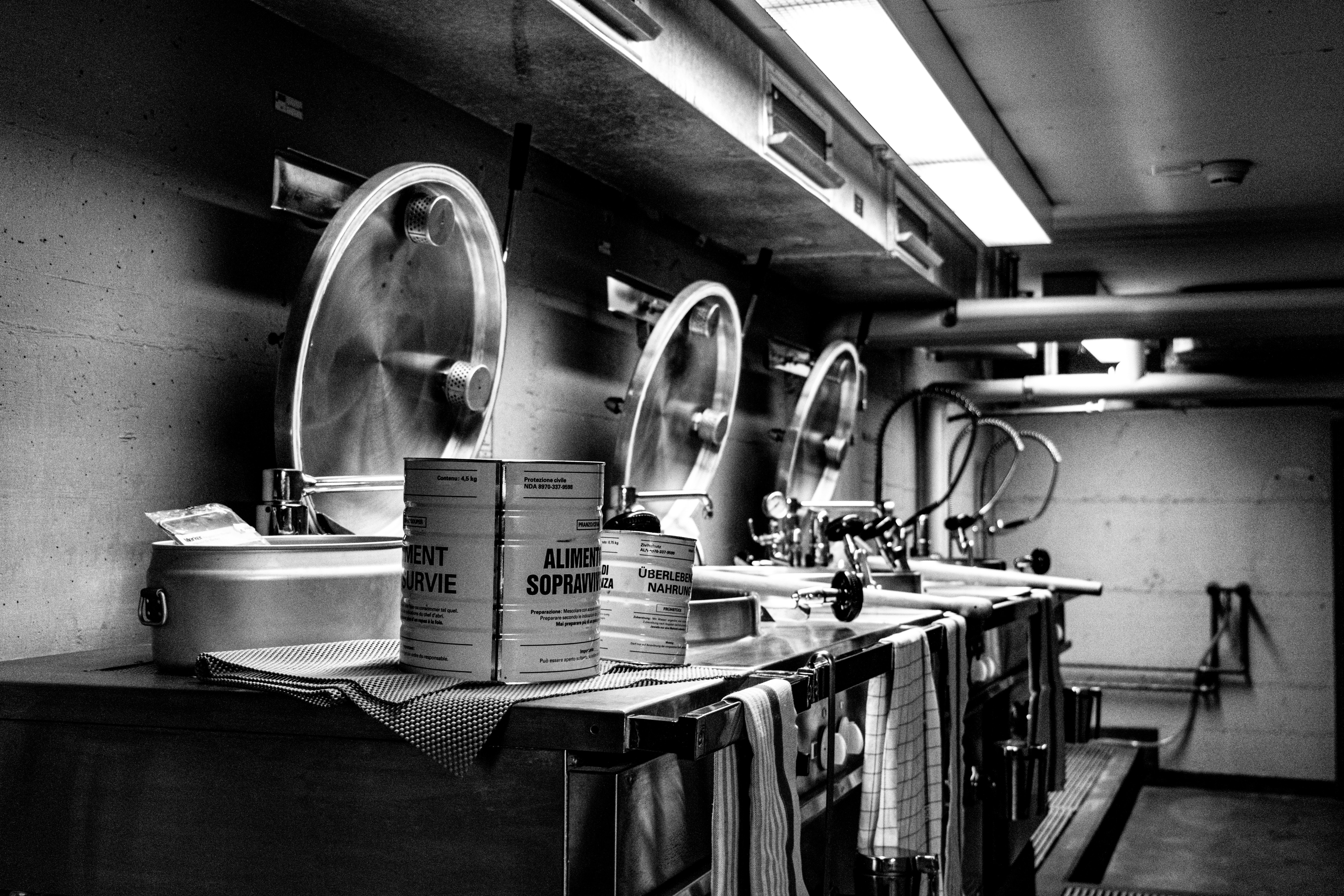 Three large industrial fans in a dimly lit room.