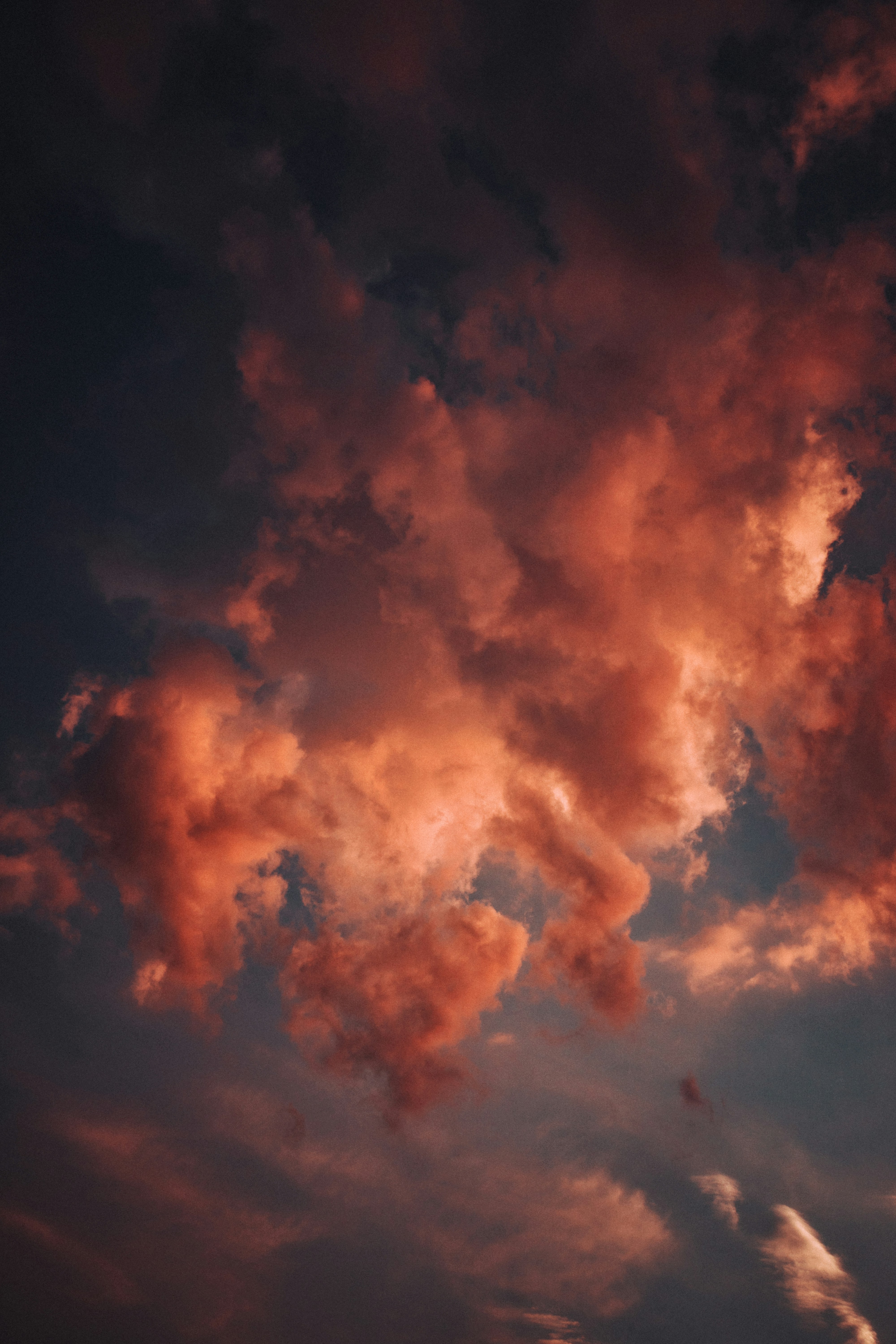 Dramatic red clouds illuminated by sunset light.