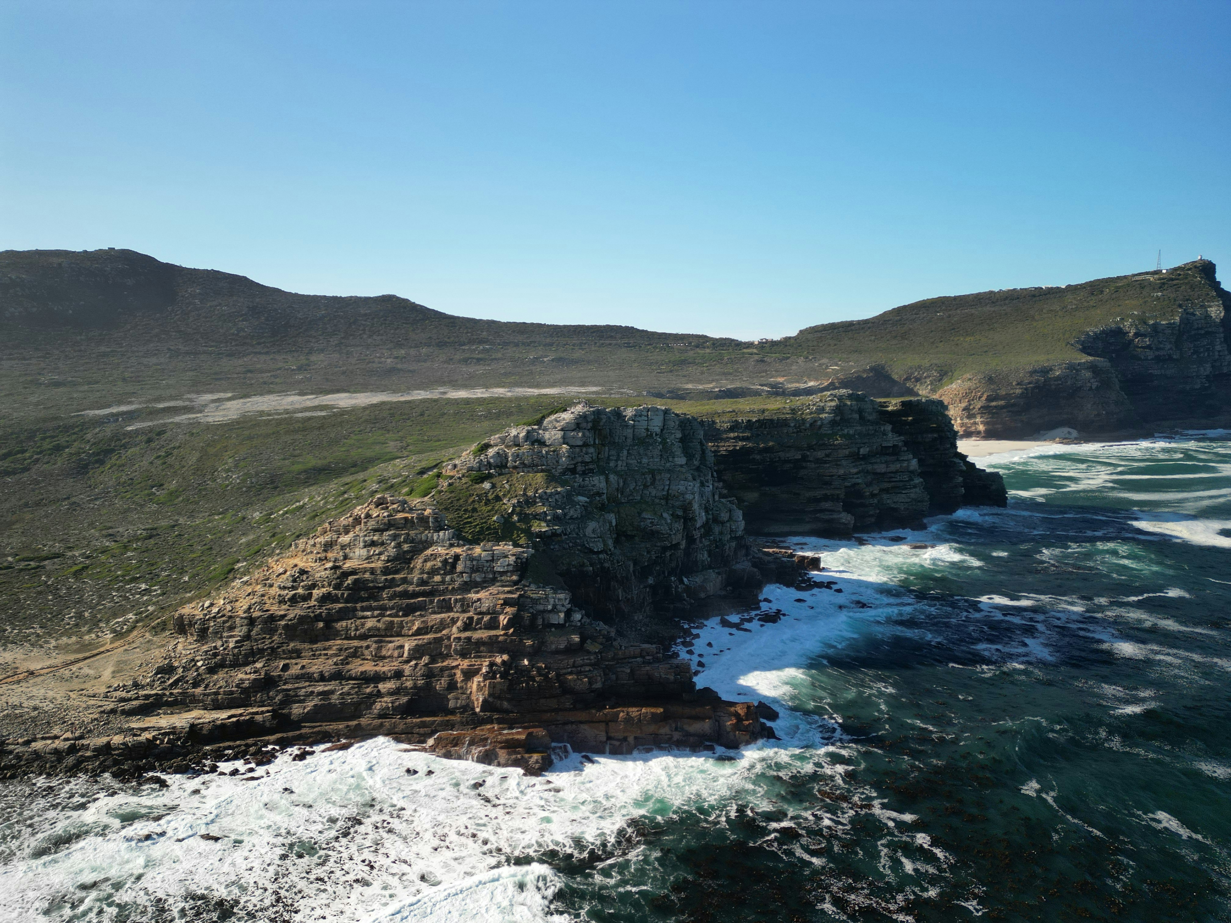 Rocky coastline with waves crashing against cliffs