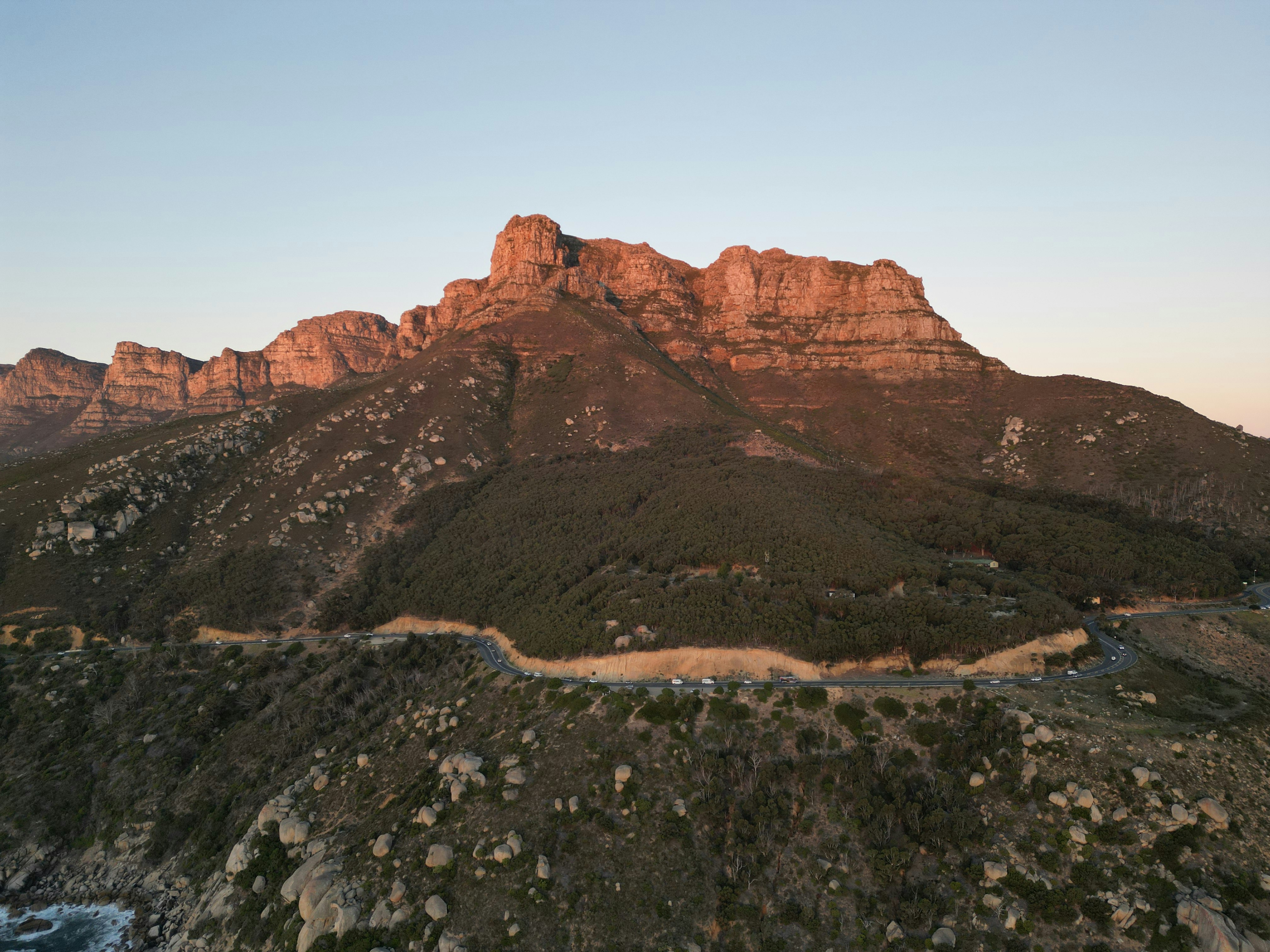 Rocky mountain range illuminated by golden hour sunlight