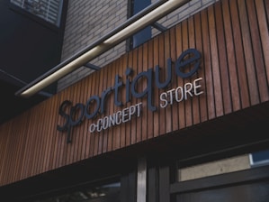 Sportique by concept store storefront sign