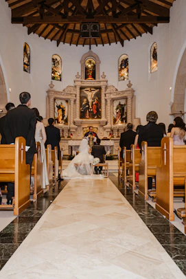 Wedding ceremony taking place at an altar in a church.