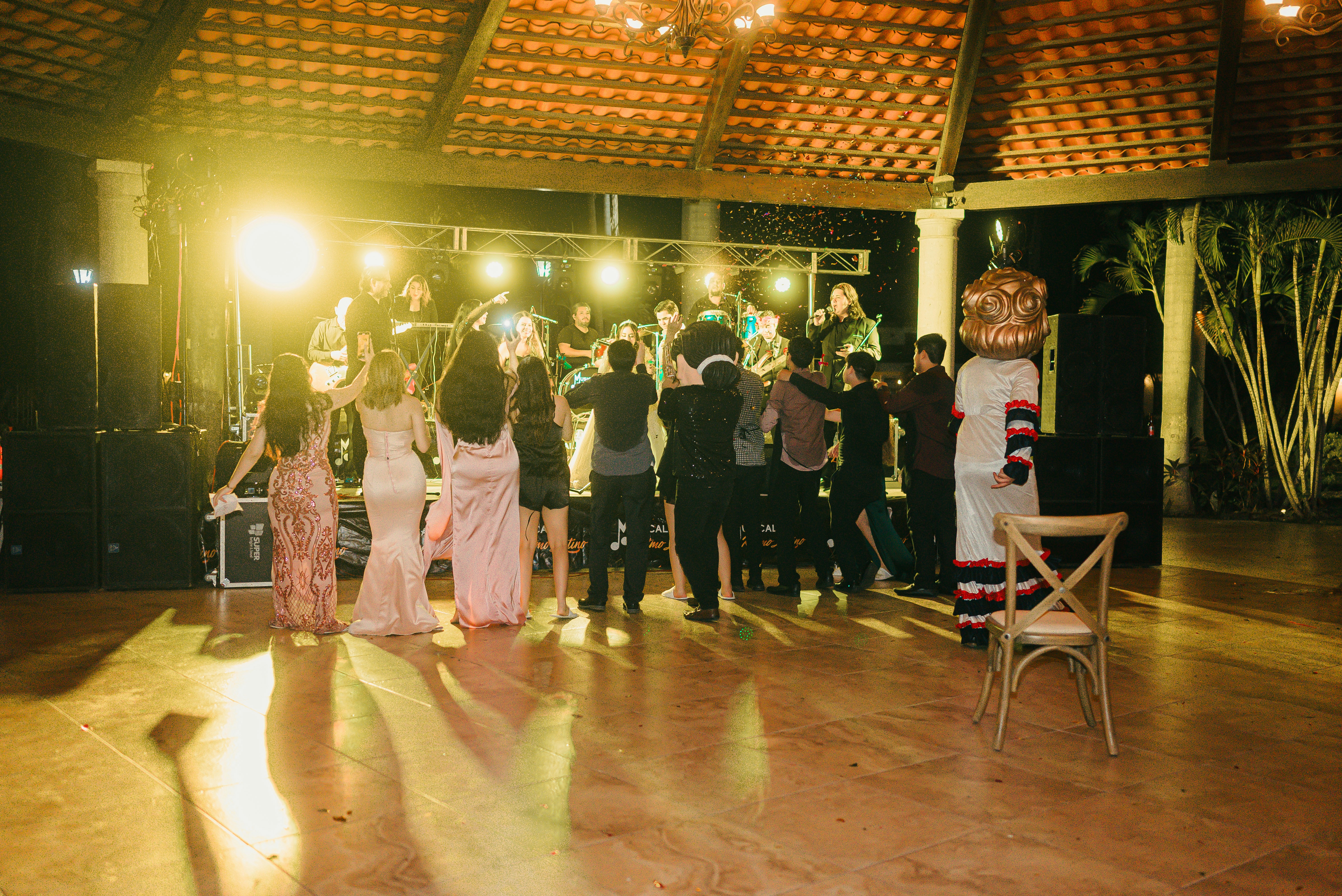 People dancing at a party with a live band
