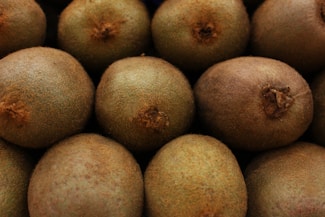 A close-up of ripe kiwifruit stacked together