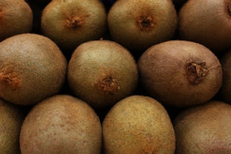 A close-up of ripe kiwifruit stacked together