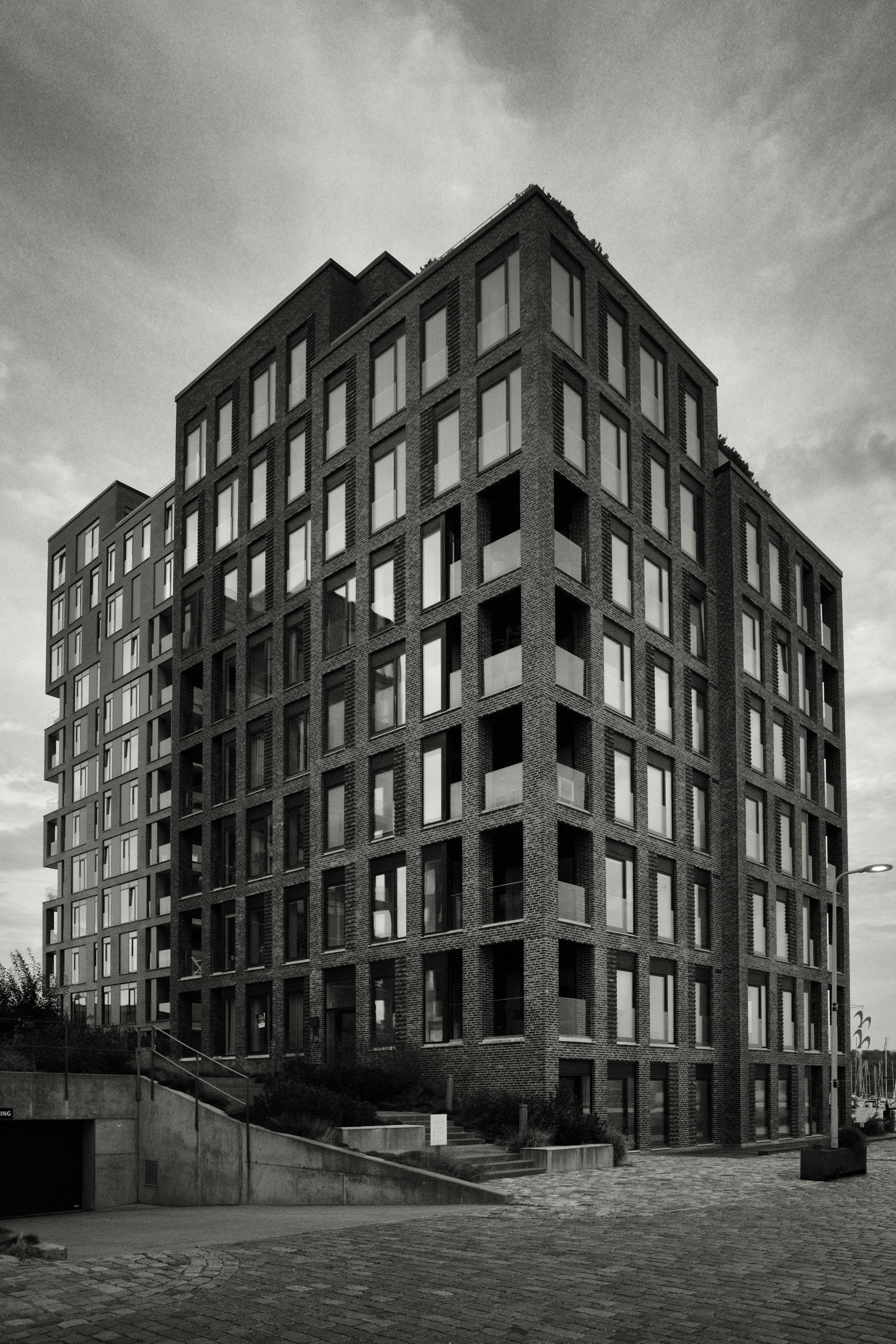 Modern brick apartment building with many windows.
