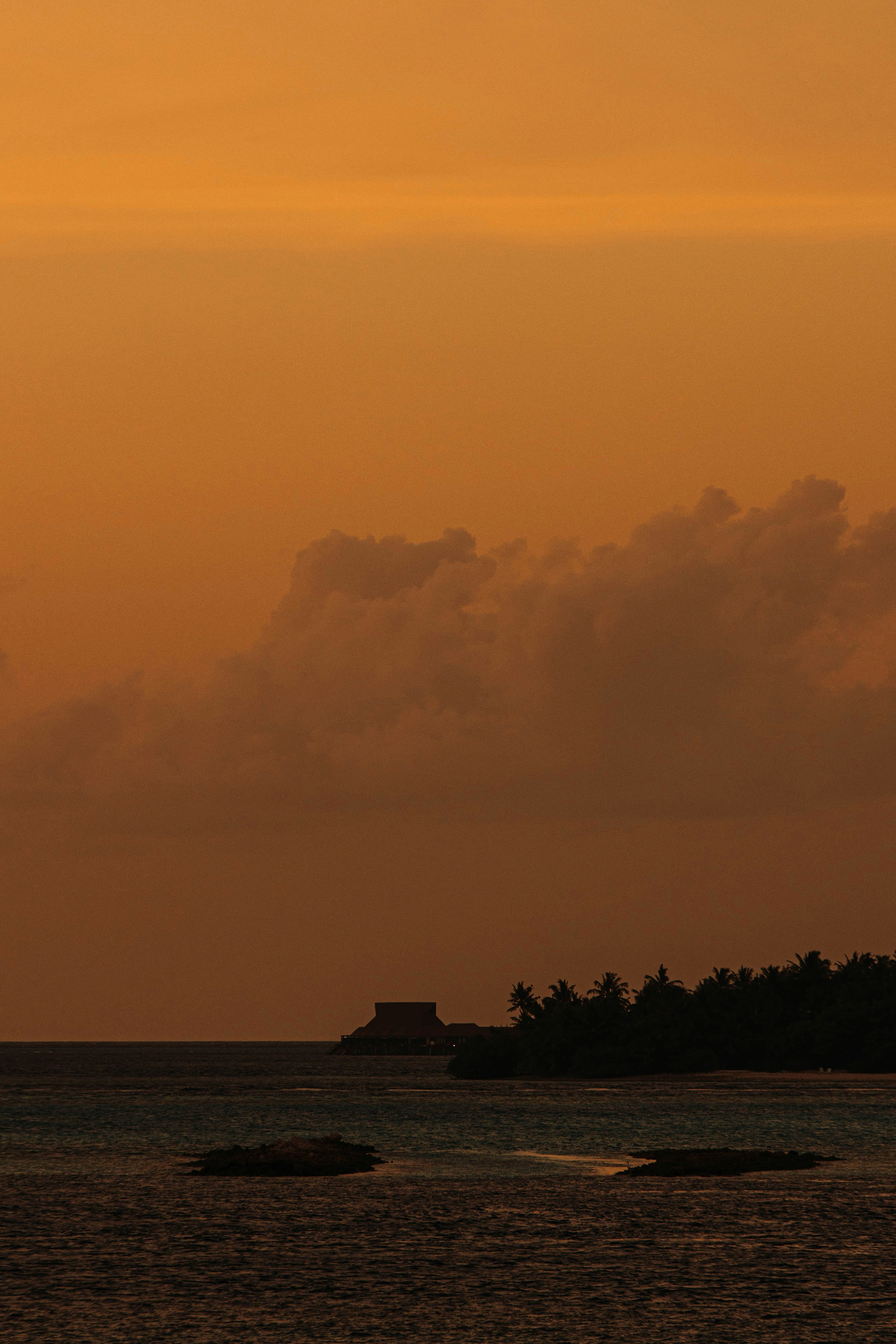 Silhouette of a tropical island at sunset.