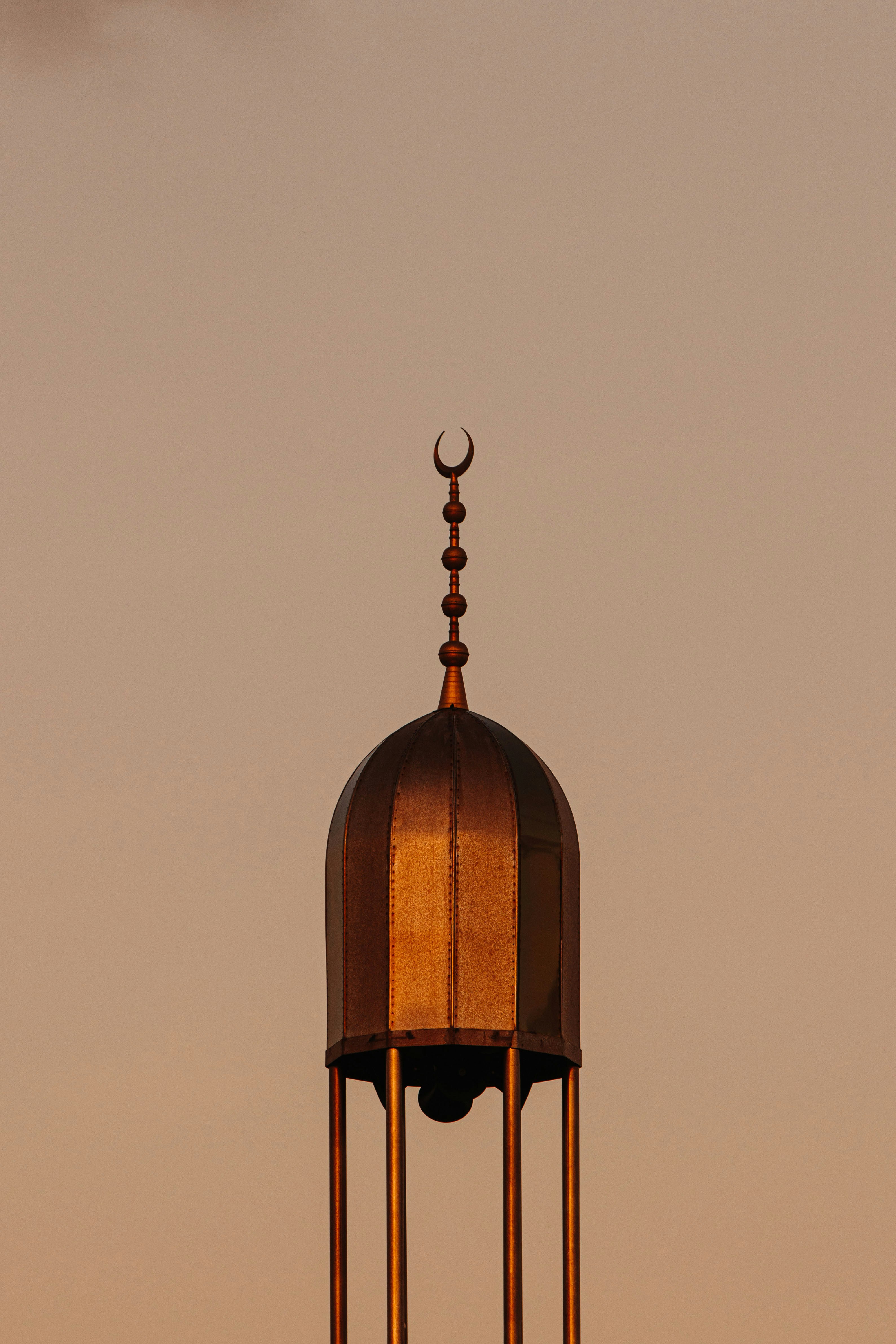 Golden mosque dome with crescent moon against sky