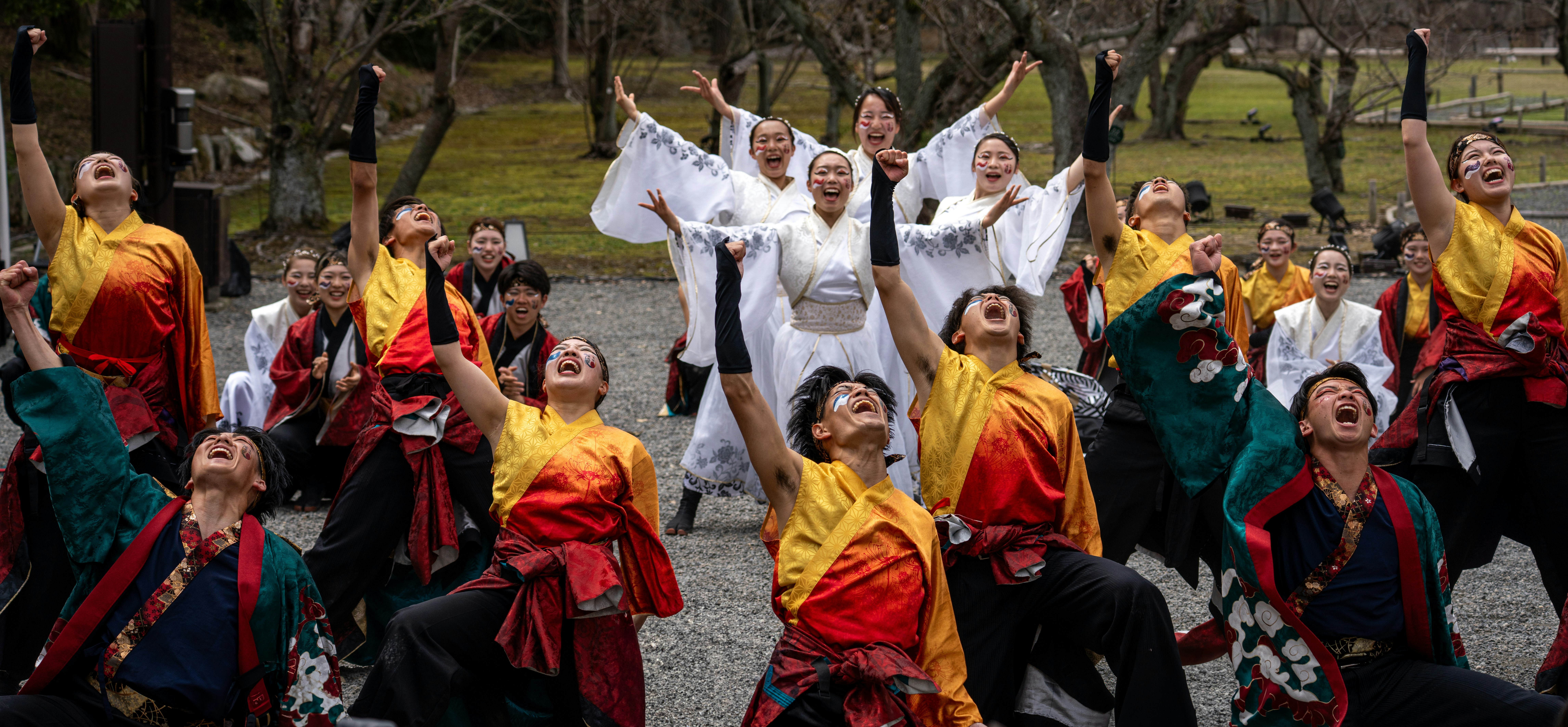 Group celebrates with arms raised outdoors