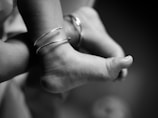 Close-up of a baby's feet wearing bracelets