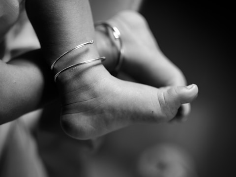 Close-up of a baby's feet wearing bracelets