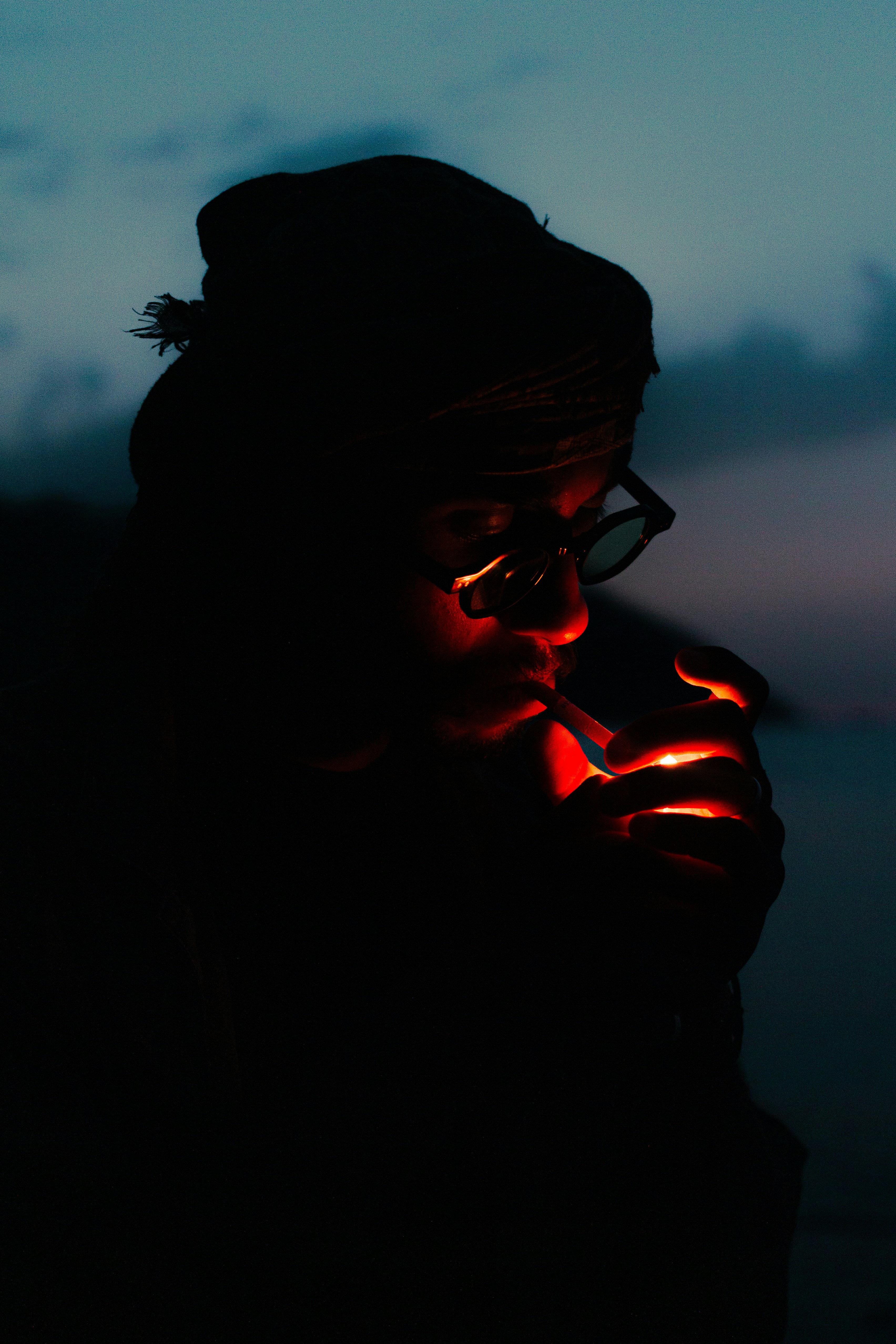 cigarette under night vision Person lighting a cigarette at dusk photo – Free Red Image on Unsplash