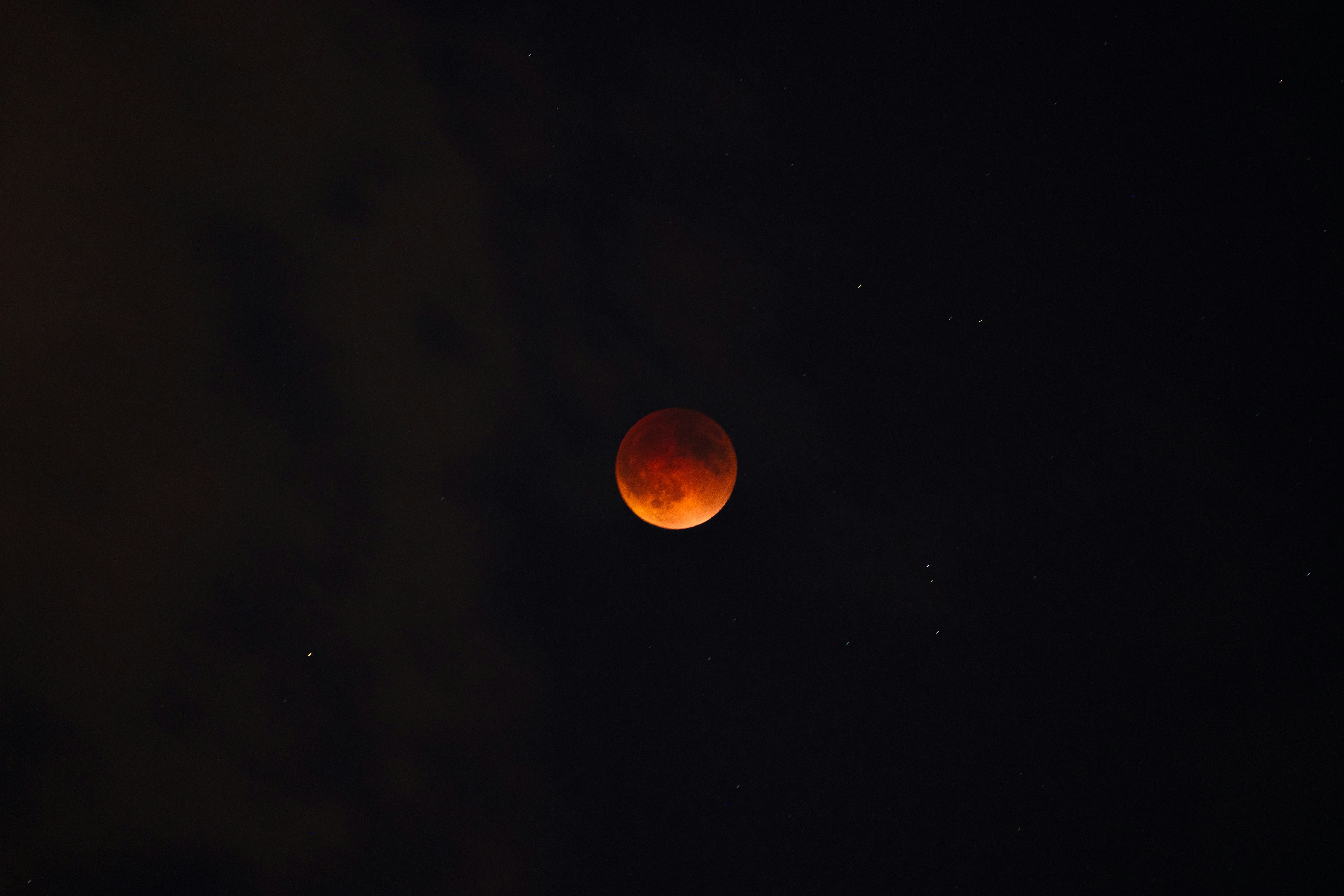 Blood moon eclipsed in a starry night sky