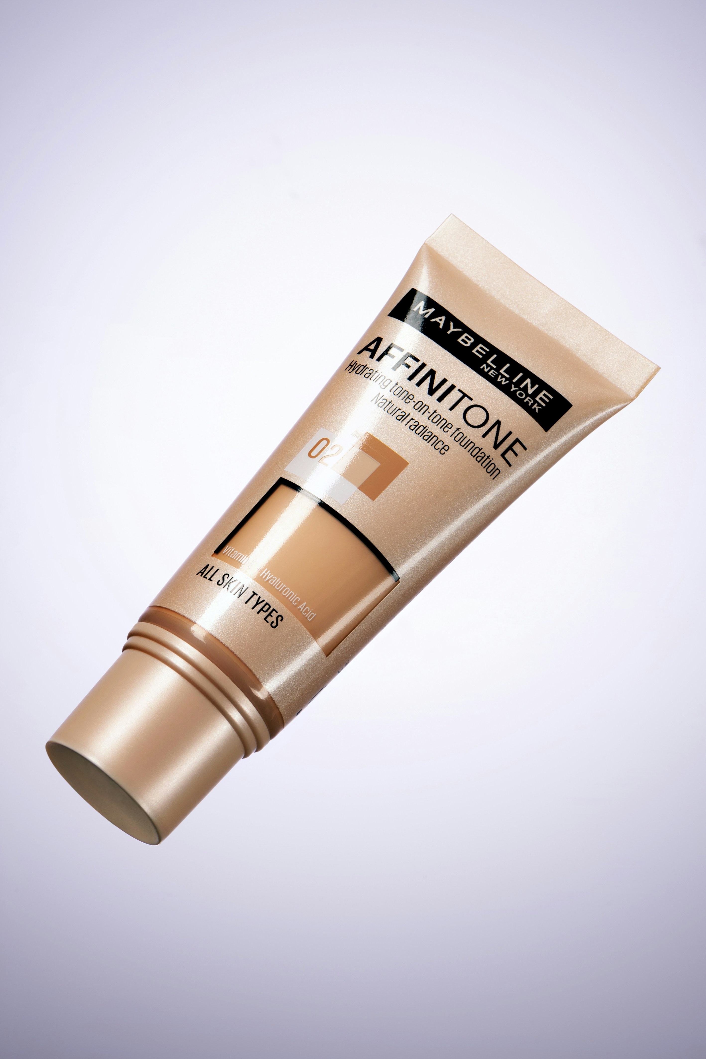 Tubo de fundação de affinitone Maybelline em fundo branco