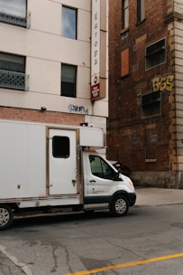 White delivery truck parked on a city street.