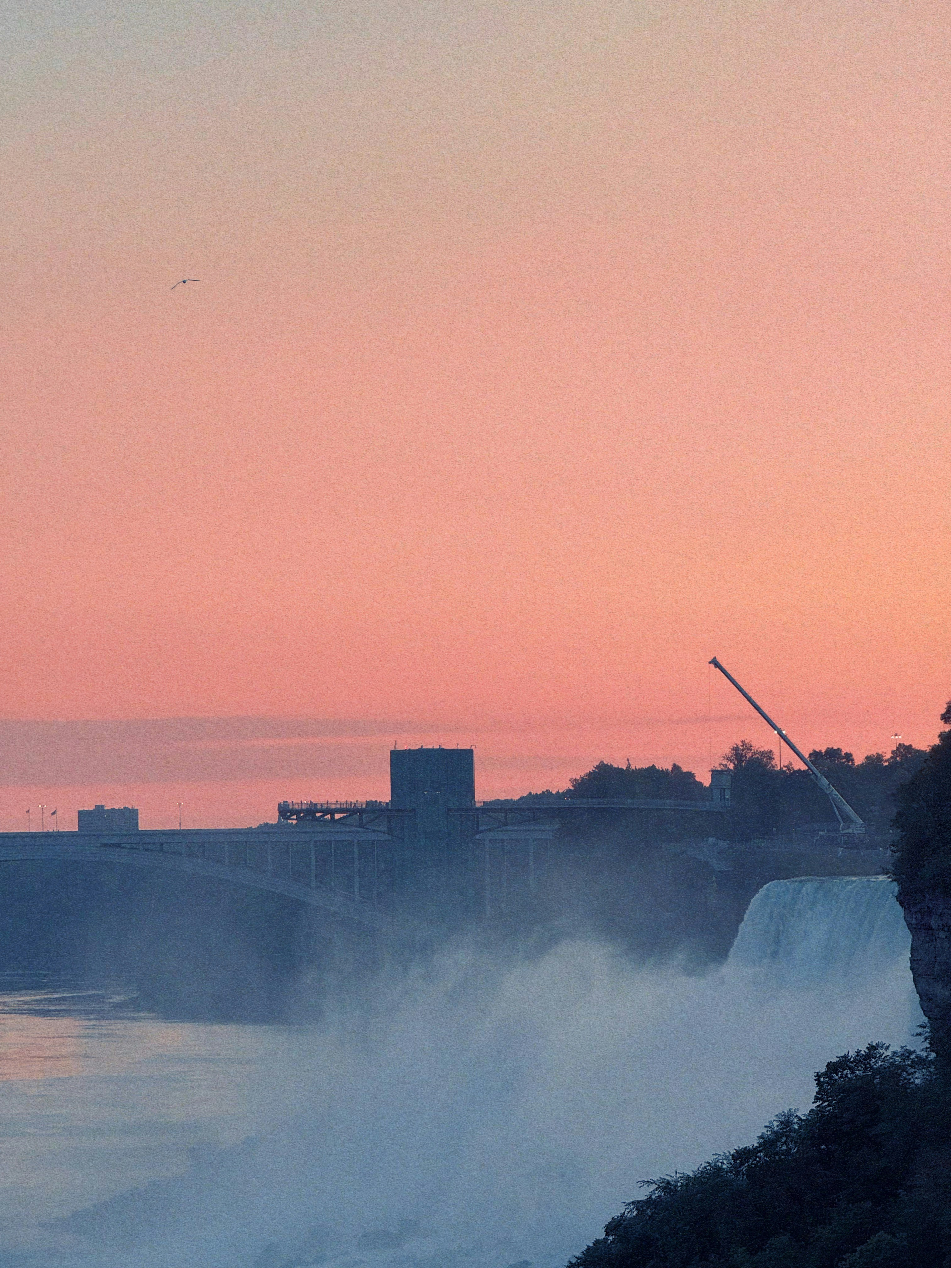 Niagara falls with a soft pink sky at sunset