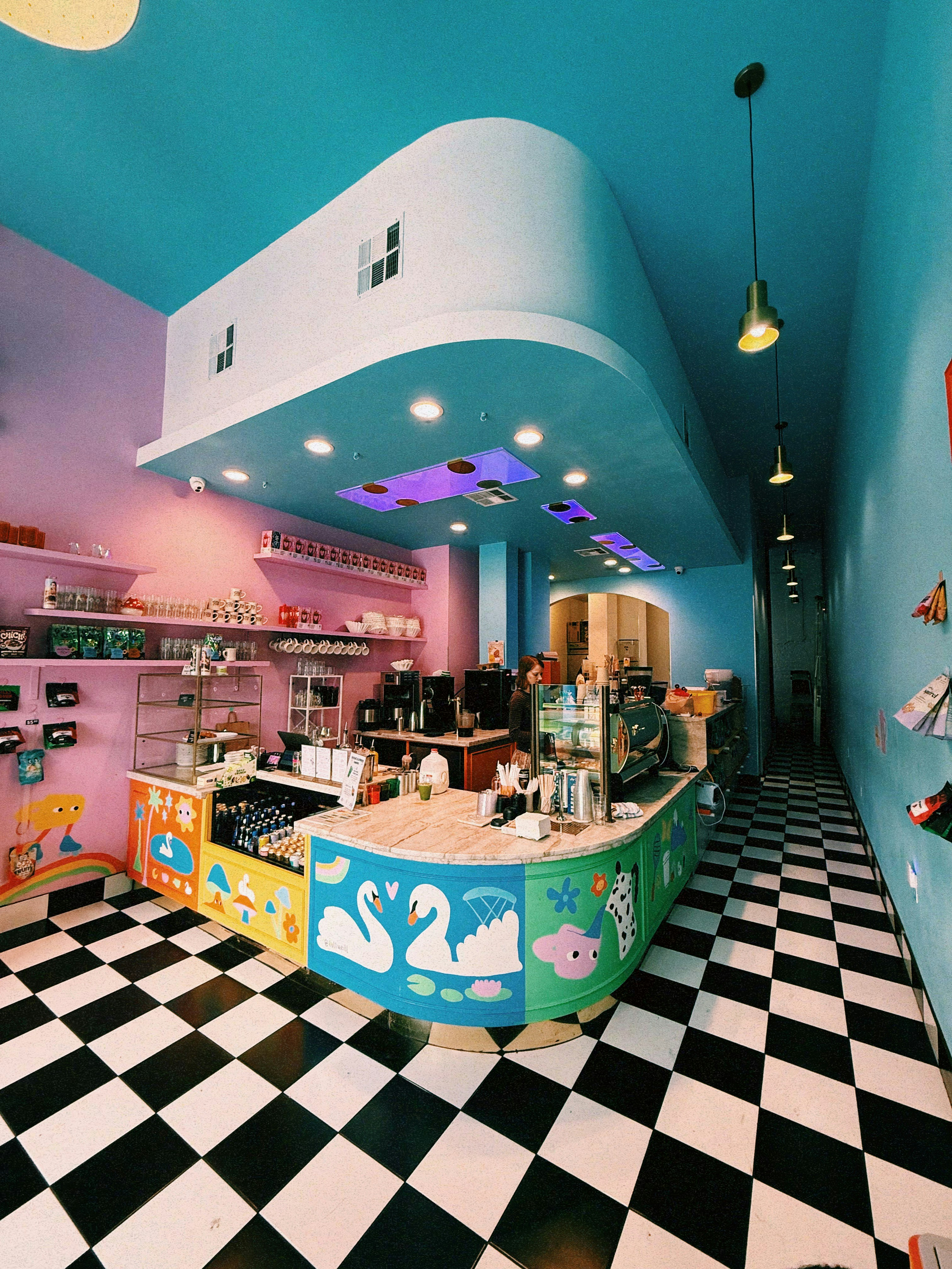 A colorful cafe interior with a checkered floor.