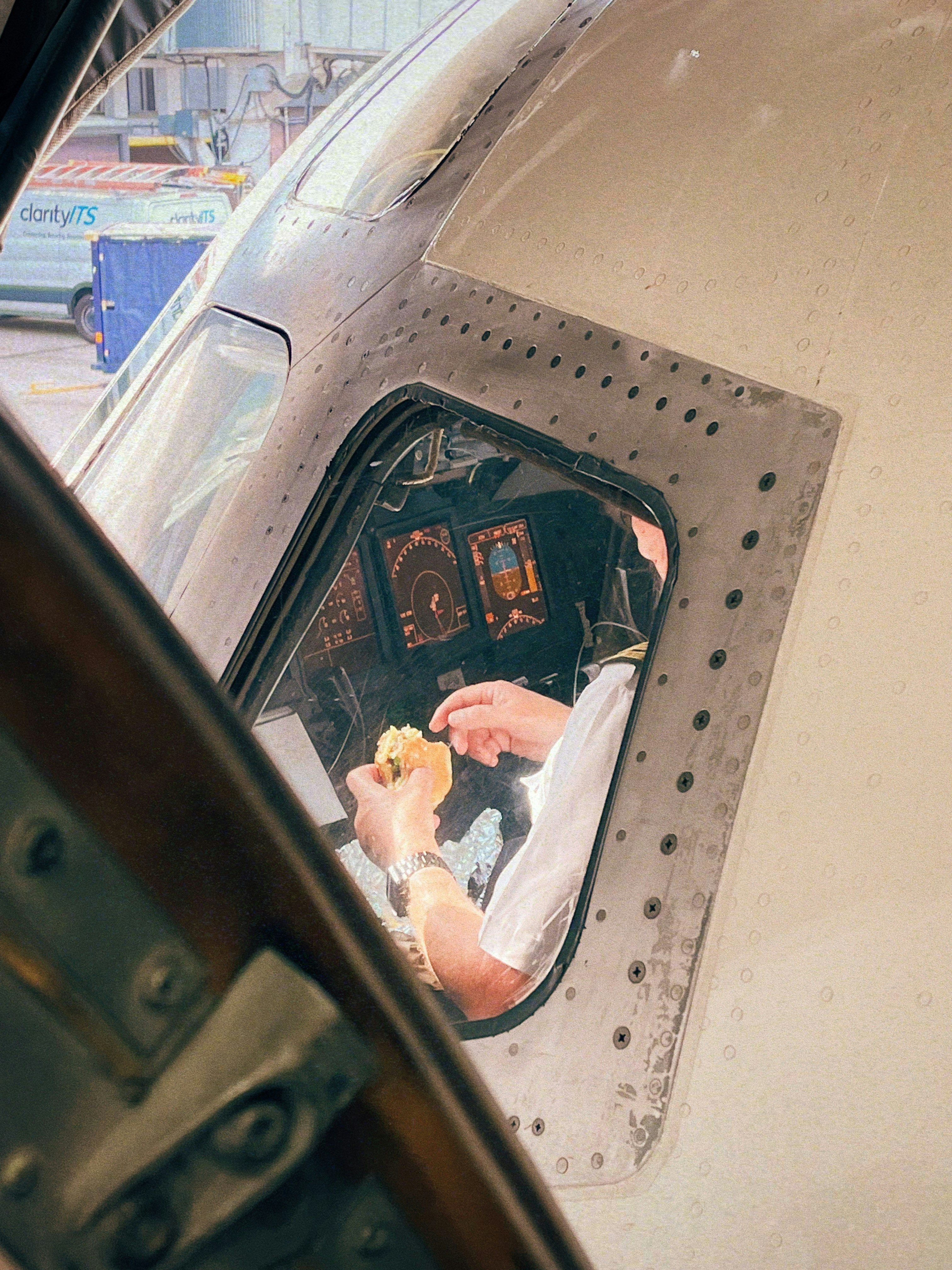 Pilot eating a sandwich in the cockpit