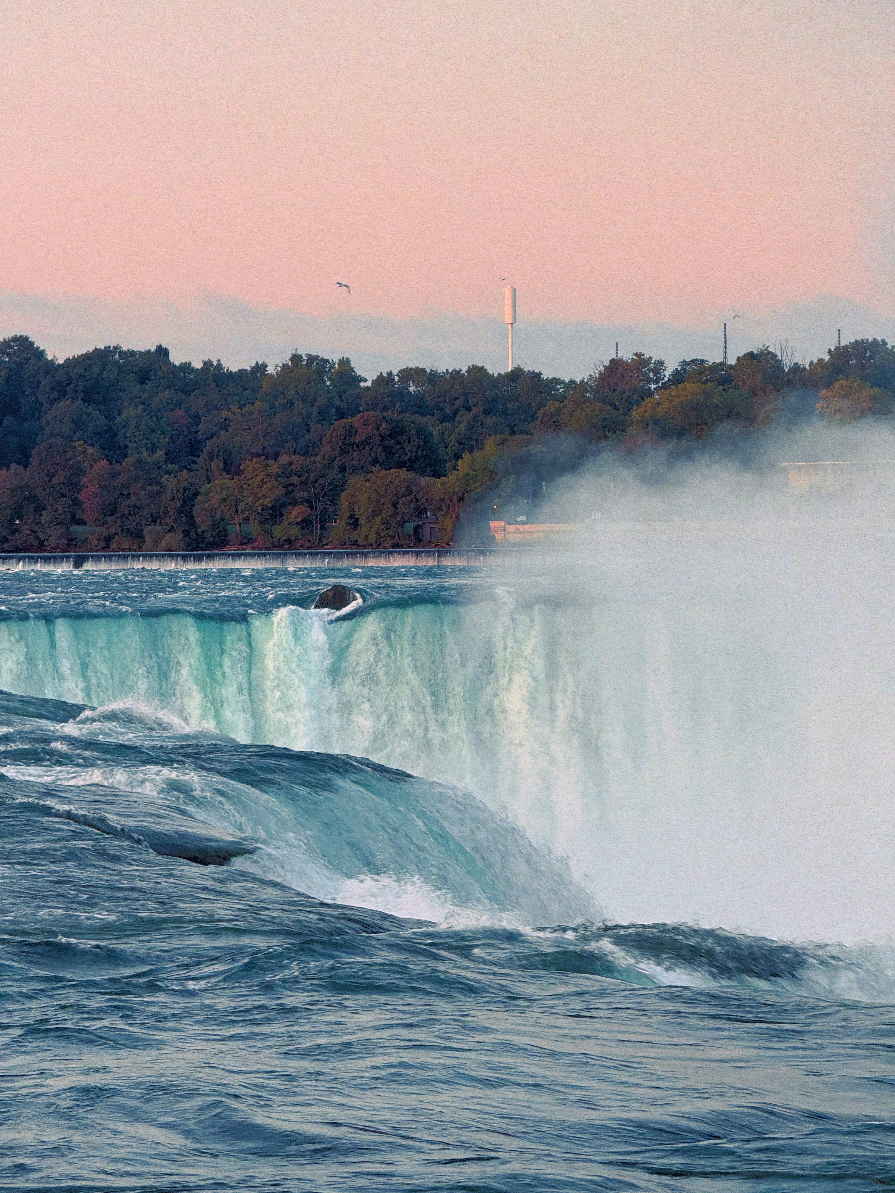 Niagara falls with mist rising at sunset