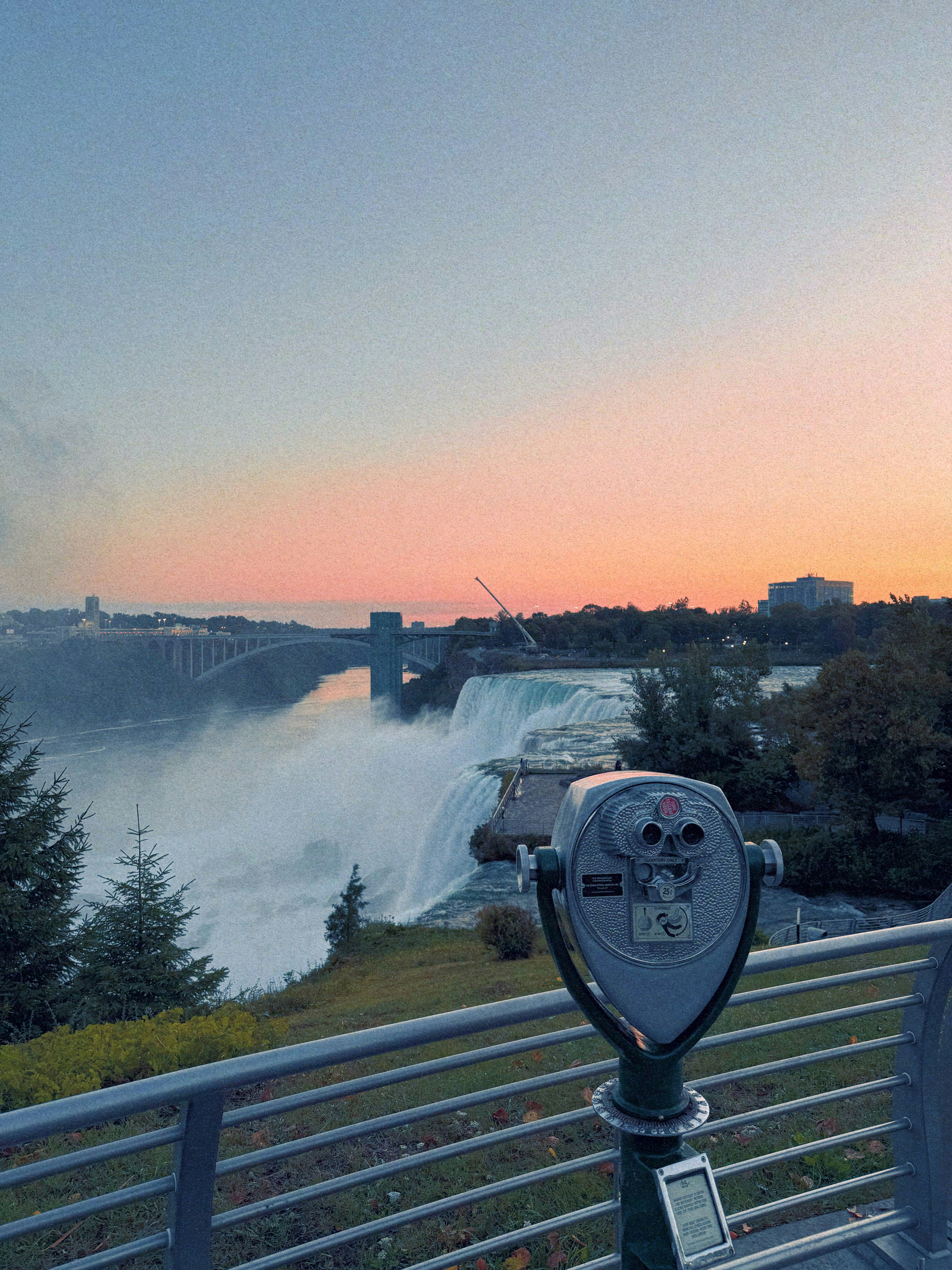 Niagara falls with a viewing scope at sunset