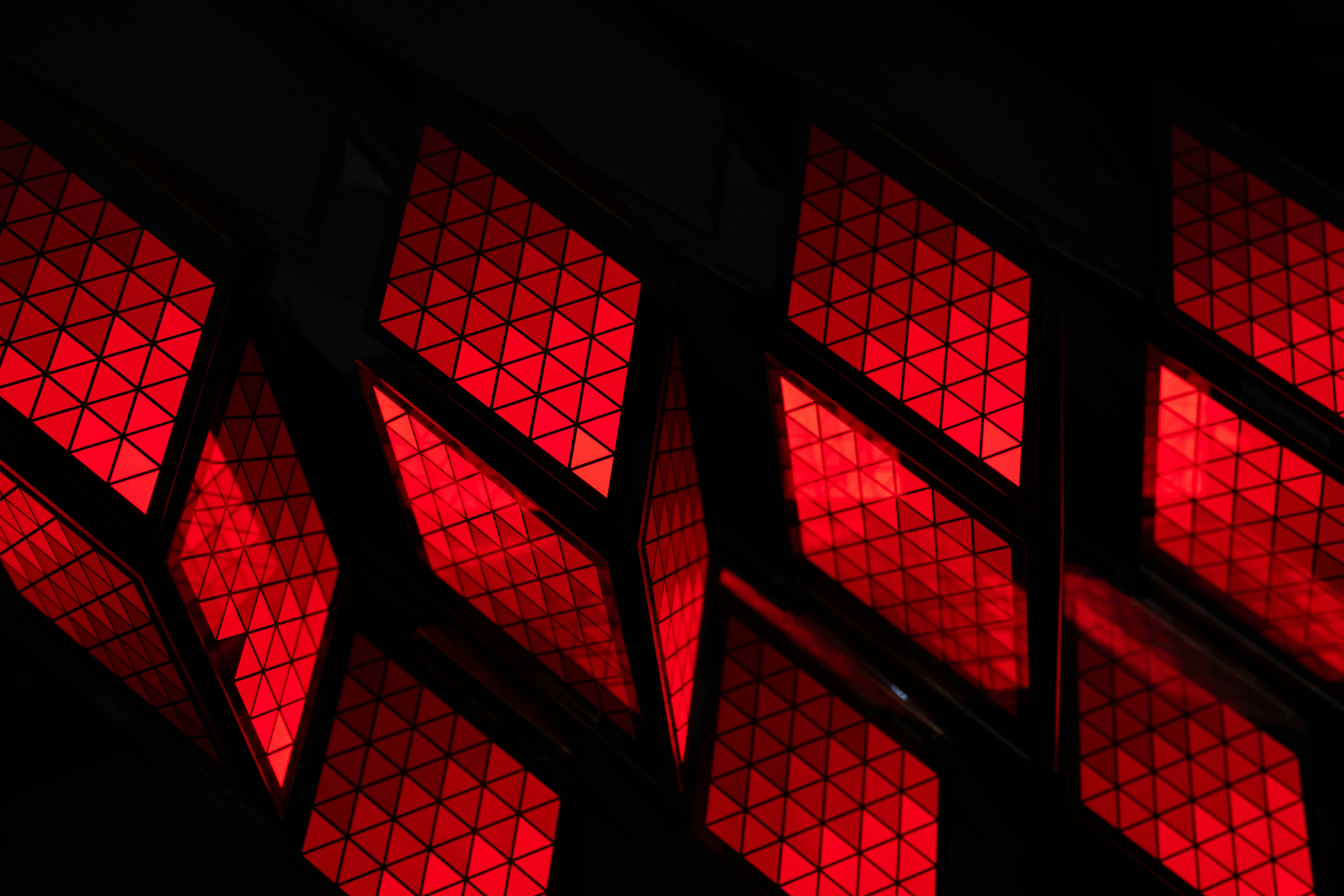 Red diamond shapes with textured patterns against black
