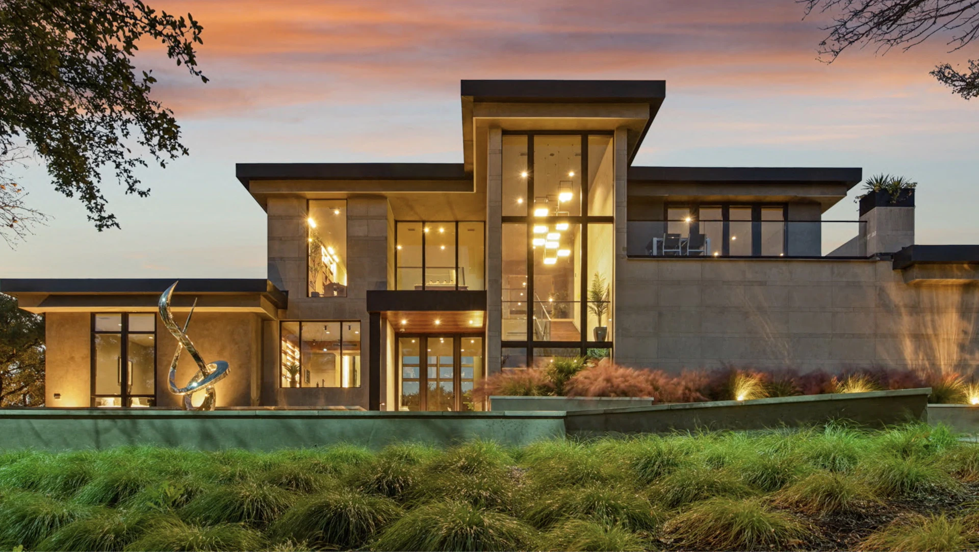 Modern luxury home with large windows at dusk