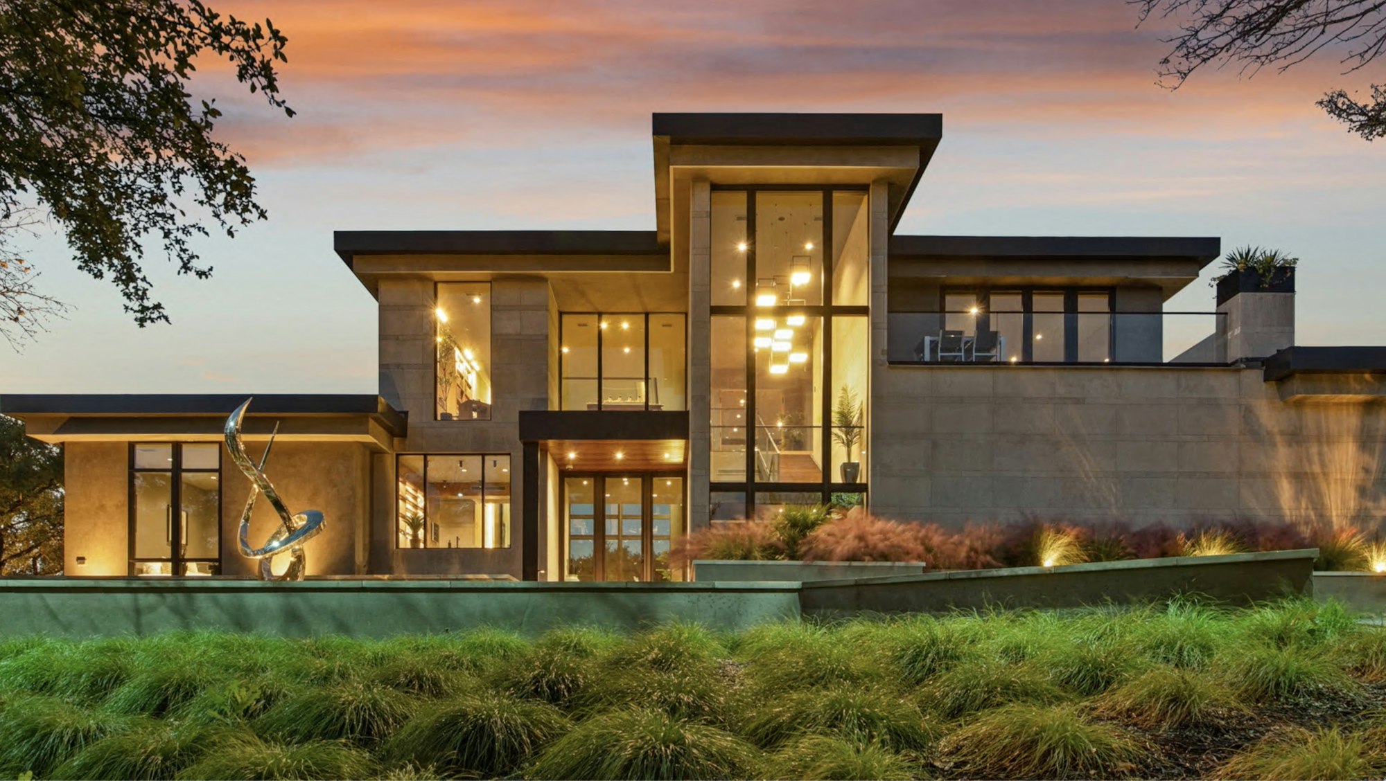 Modern home lit at dusk