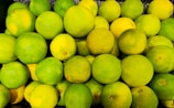 A pile of fresh green and yellow limes.