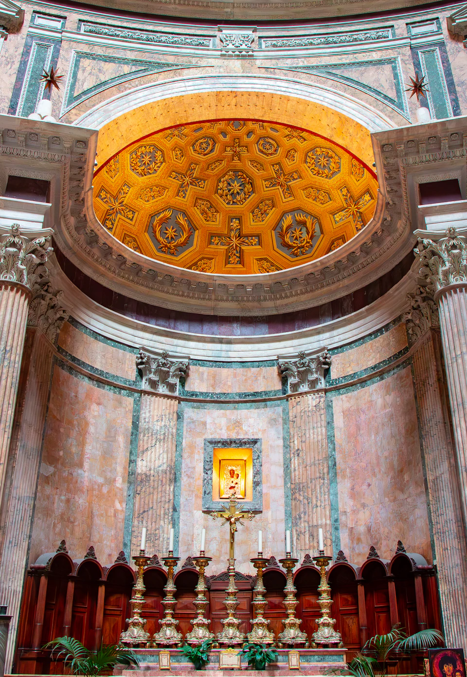 Large ornate room with dome ceiling and intricate carvings features a grand altar structure