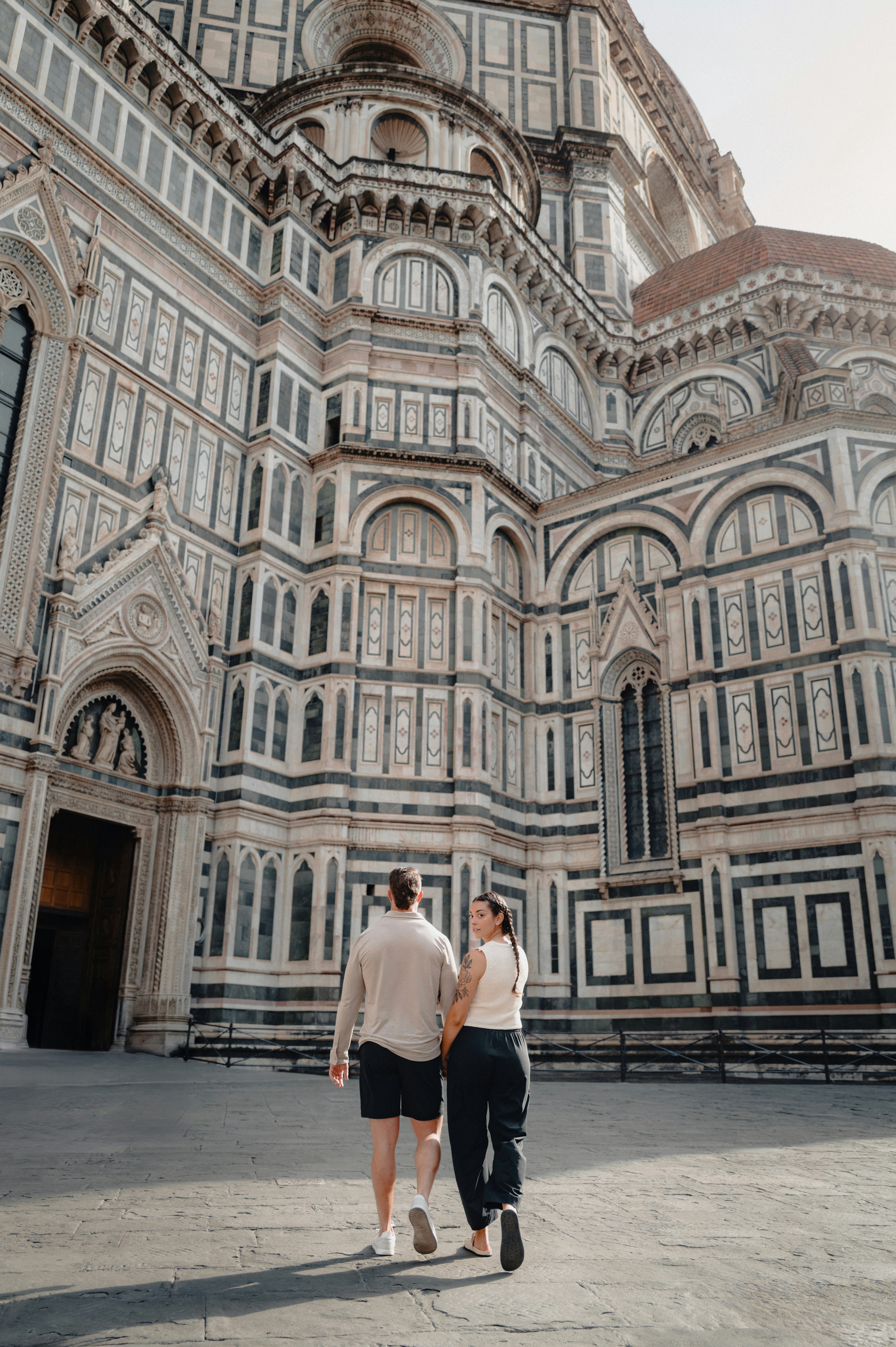 Couple walking towards a grand cathedral
