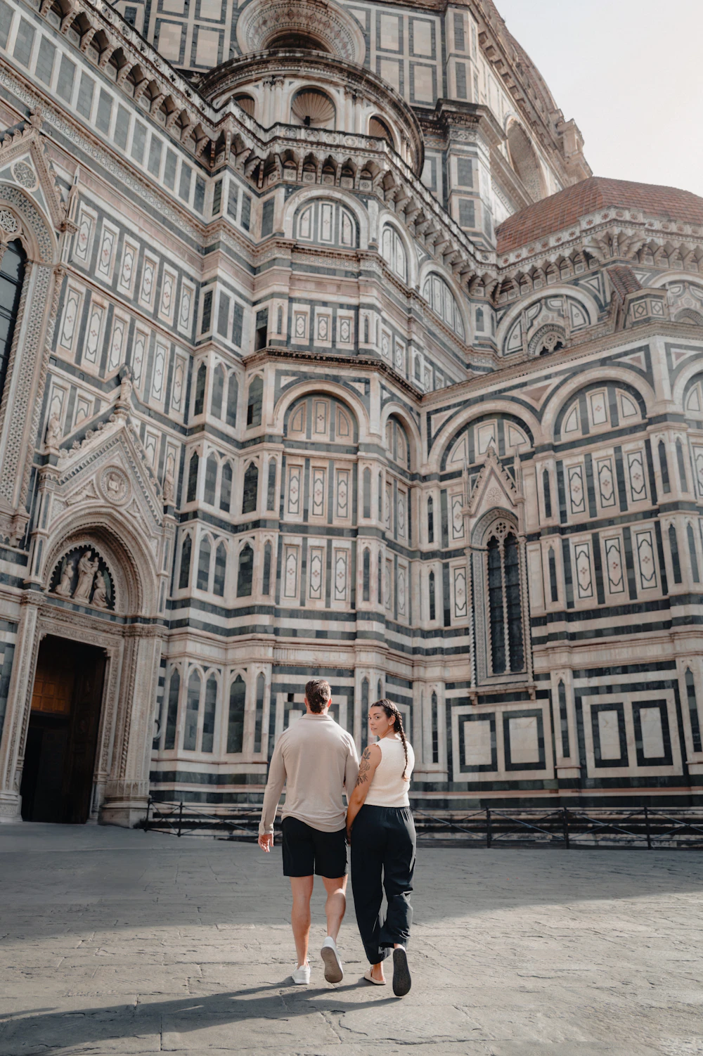 Sofia and James walking toward Florence Cathedral