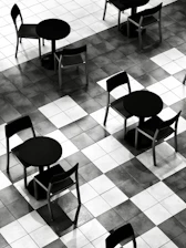 Empty tables and chairs on a checkered floor