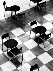 Empty tables and chairs on a checkered floor