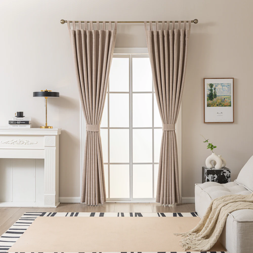 Floor-length beige curtains framing a tall window