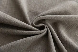 Textured gray fabric folded in a swirl