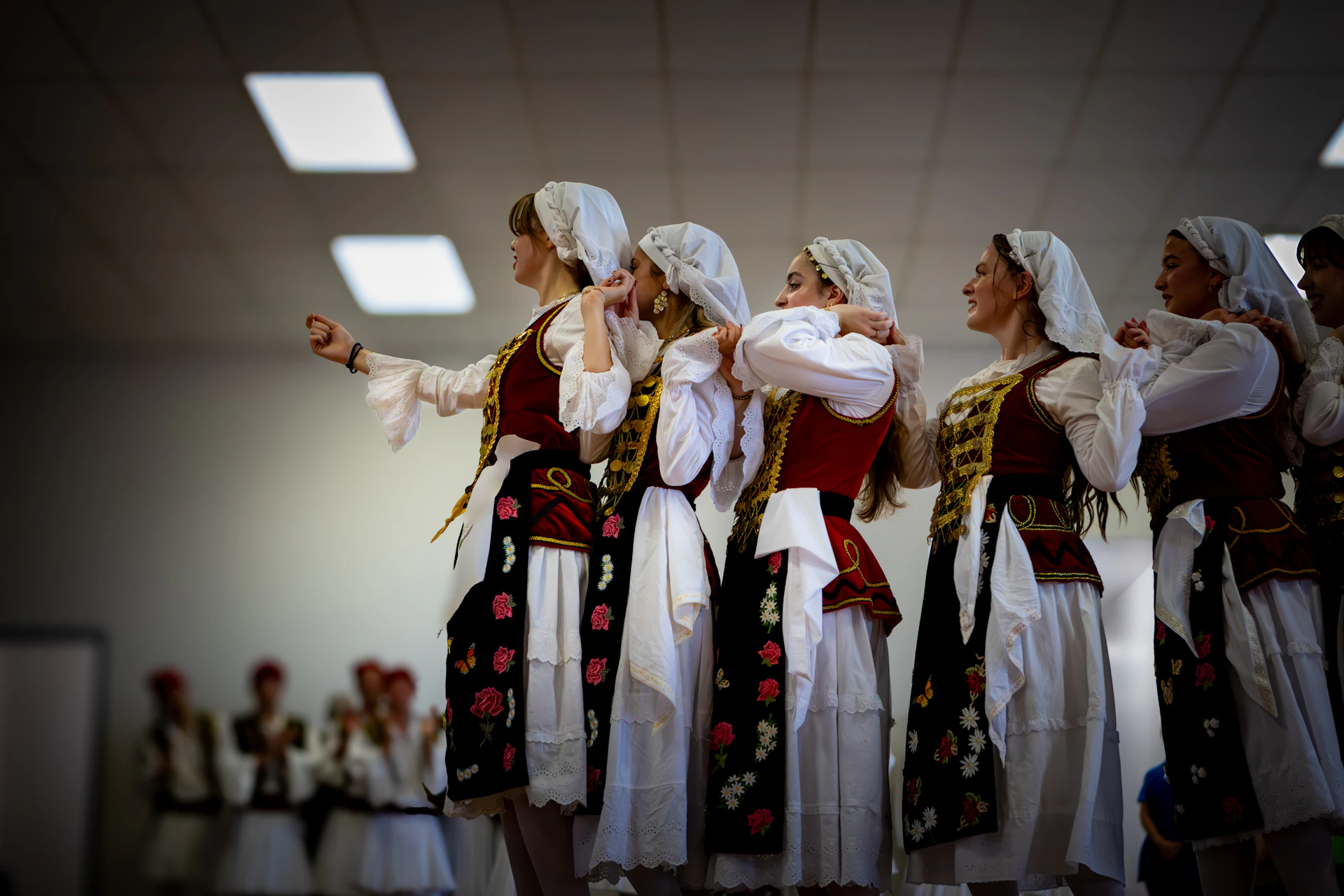 Women in traditional folk costumes performing a dance